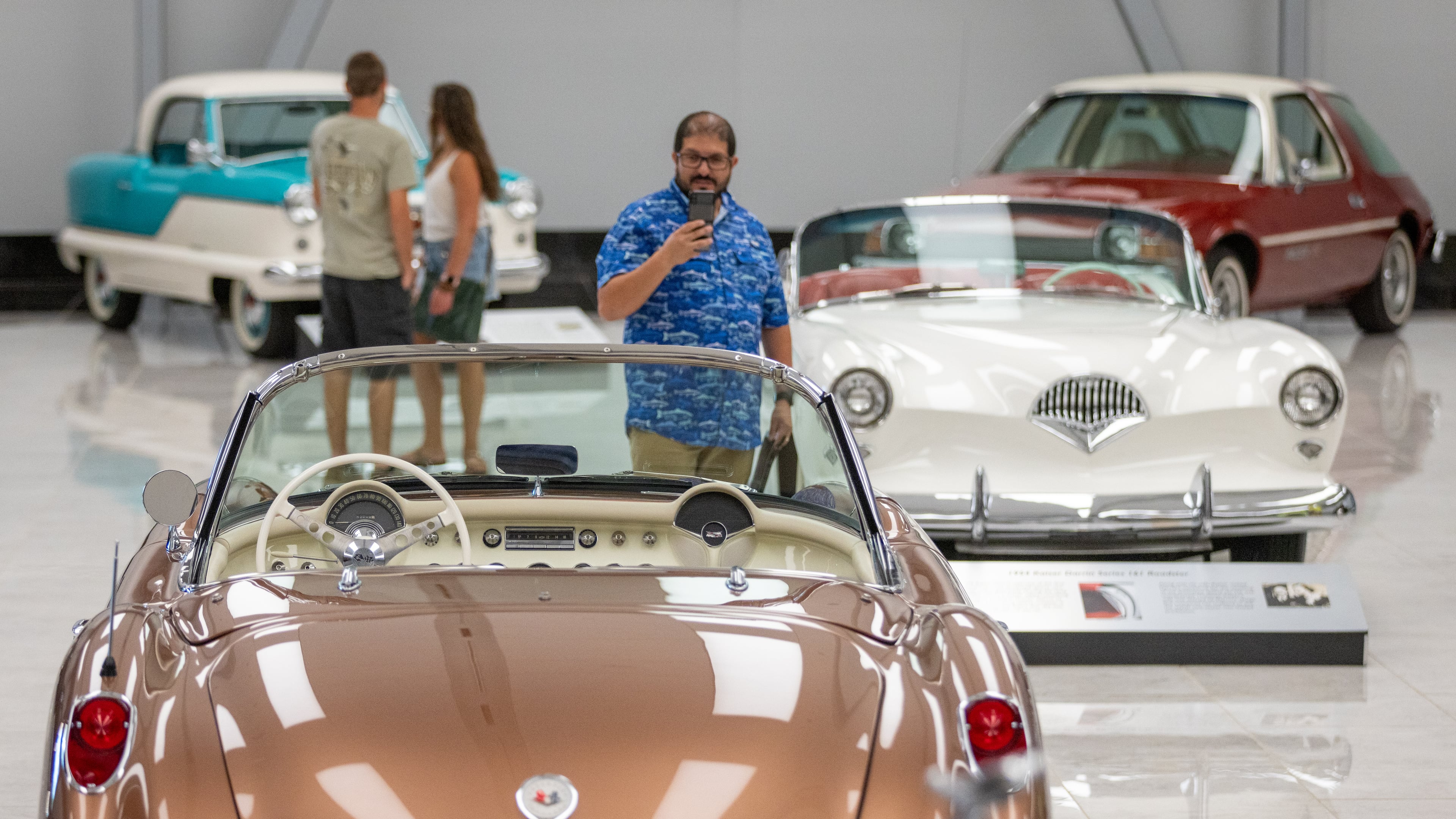 Miguel Feijoo takes a photo of one of the cars on exhibit at the Savory Automobile Museum in Cartersville. Steve Schaefer/steve.schaefer@ajc.com)