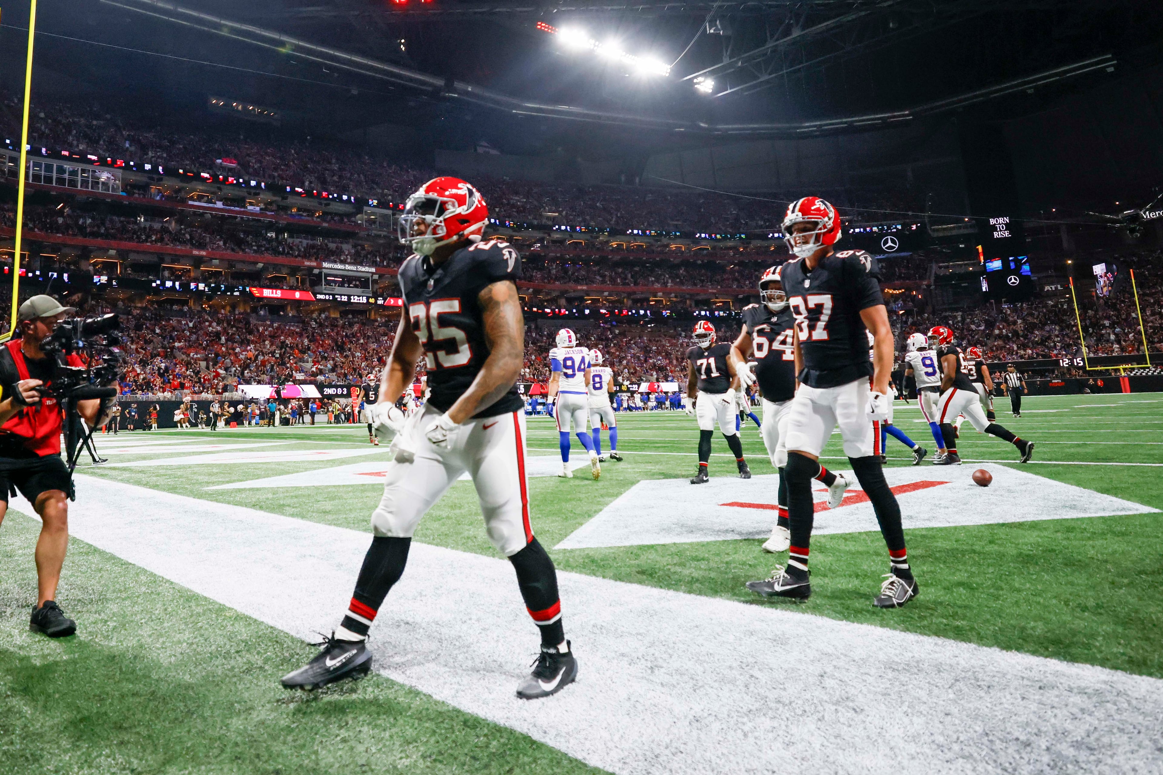 Atlanta Falcons running back Tyler Allgeier (front) celebrates after scoring a touchdown during the first half of an NFL game against the Buffalo Bills at Mercedes-Benz Stadium in Atlanta on Monday, October 13, 2025. (Miguel Martinez/AJC)