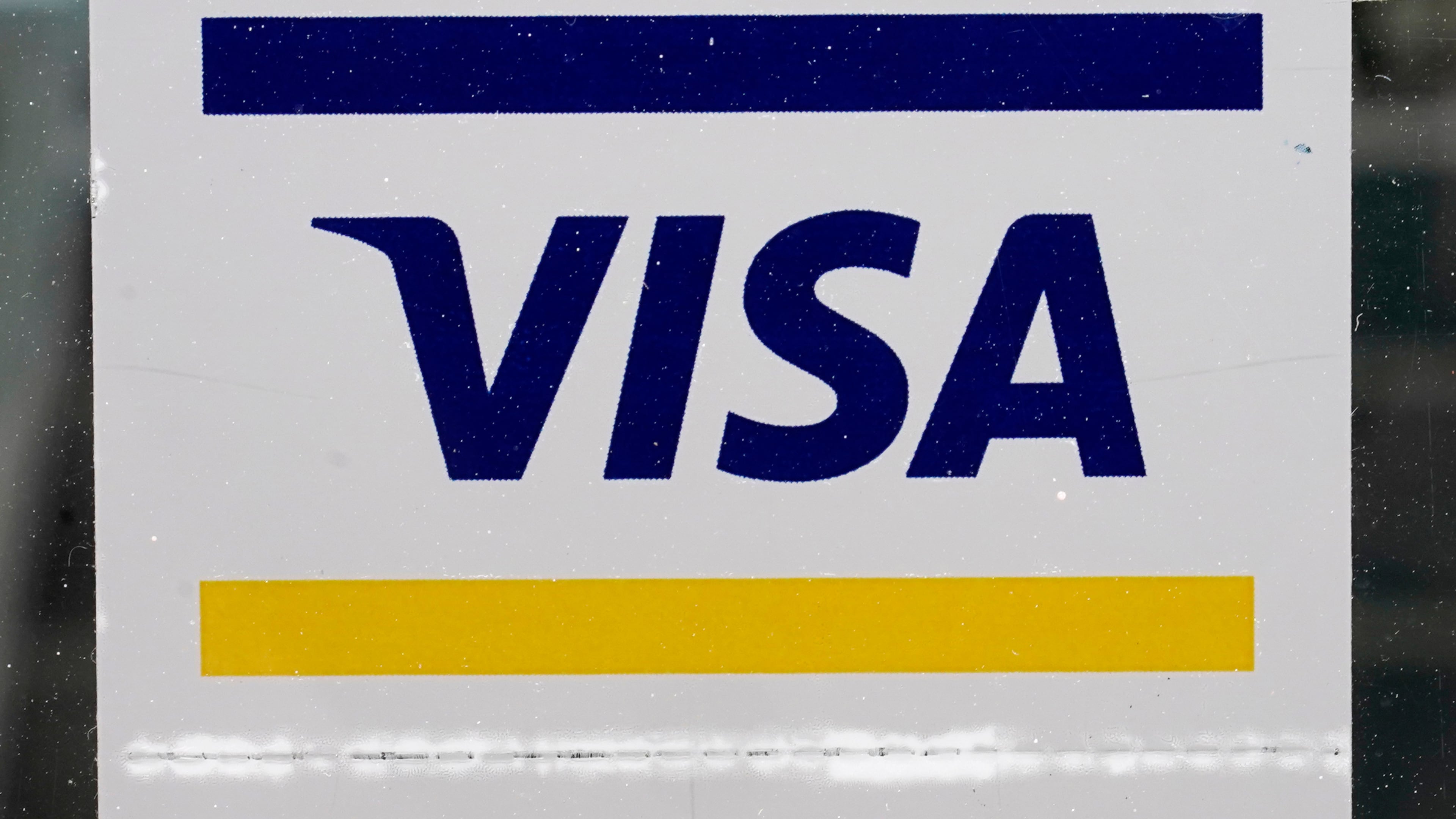 FILE -A Visa sign is displayed on the front door of a local business, April 27, 2021, in Urbandale, Iowa. (AP Photo/Charlie Neibergall, File)