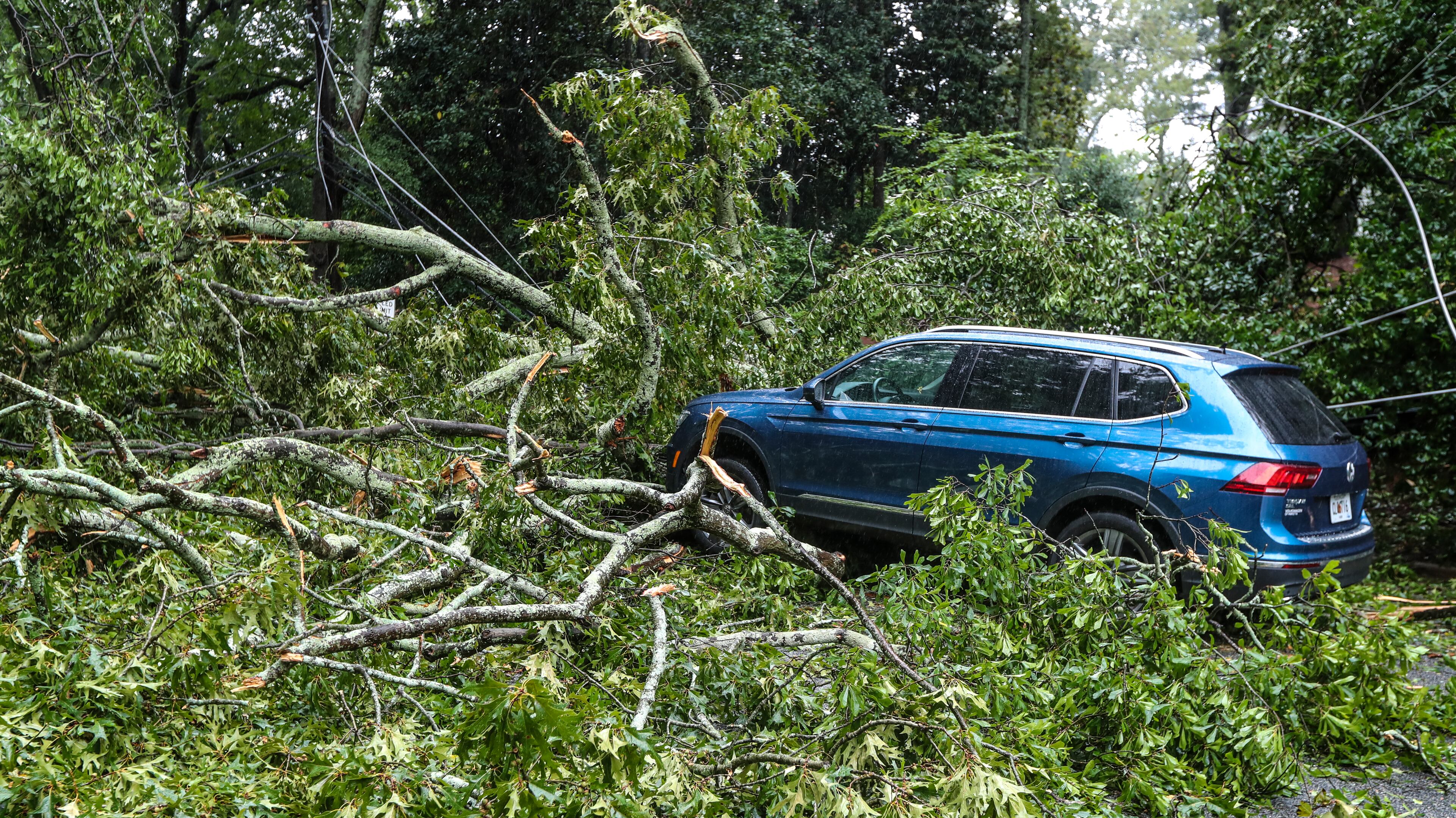 September 17, 2020 Atlanta: Atlanta Fire Rescue kept an apparatus on the scene where a tree brought wires down across Peachtree Battle at Havenridge Drive in Atlanta in Atlanta. Officials at the scene did not disclose the condition of the driver of the vehicle. Remnants of Hurricane Sally, that downgraded to a tropical depression, moved through North Georgia on Thursday, Sept. 17, 2020. Heavy rain and flooding brought trees down and made a mess of the Thursday morning commute and knocked out power to thousands. By mid-day, Fulton, DeKalb and Gwinnett counties received between 2 and 4 inches of rain, and the Southside, between 1 and 3 inches. Those areas could see as much as another 4 inches of rain before the end of the day, according to rain forecast. (John Spink / John.Spink@ajc.com)
