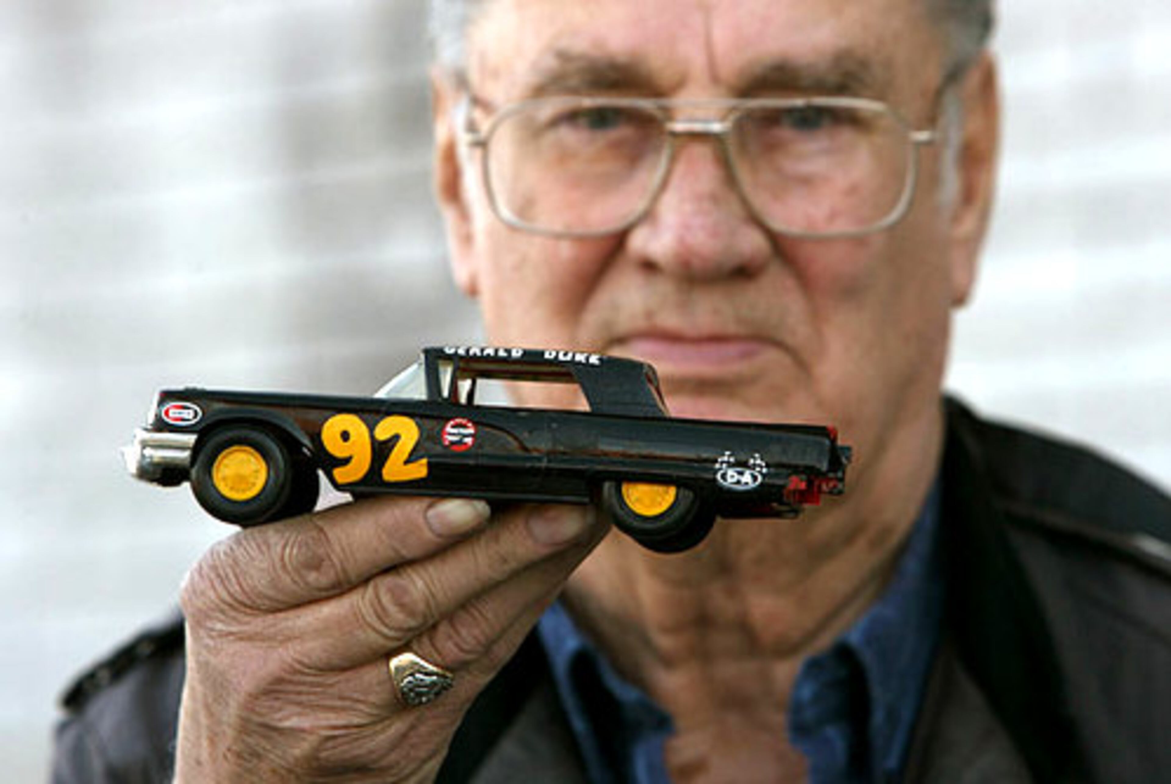 Gerald Duke ran in the 1962 Daytona 500 and now lives in College Park. He's holding a replica of his 1959 Thunderbird, which he raced in 1960.