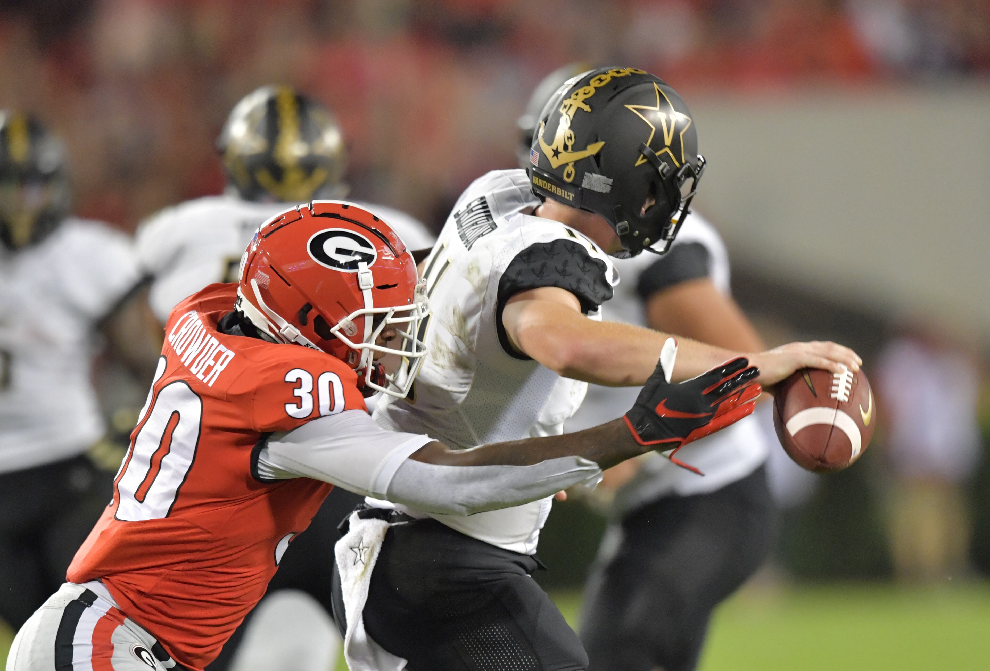October 6, 2018 Athens - Vanderbilt quarterback Kyle Shurmur (14) is hit by Georgia linebacker Tae Crowder (30) causing a fumble in the first half during a NCAA college football game at Sanford Stadium in Athens on Saturday, October 6, 2018. HYOSUB SHIN / HSHIN@AJC.COM