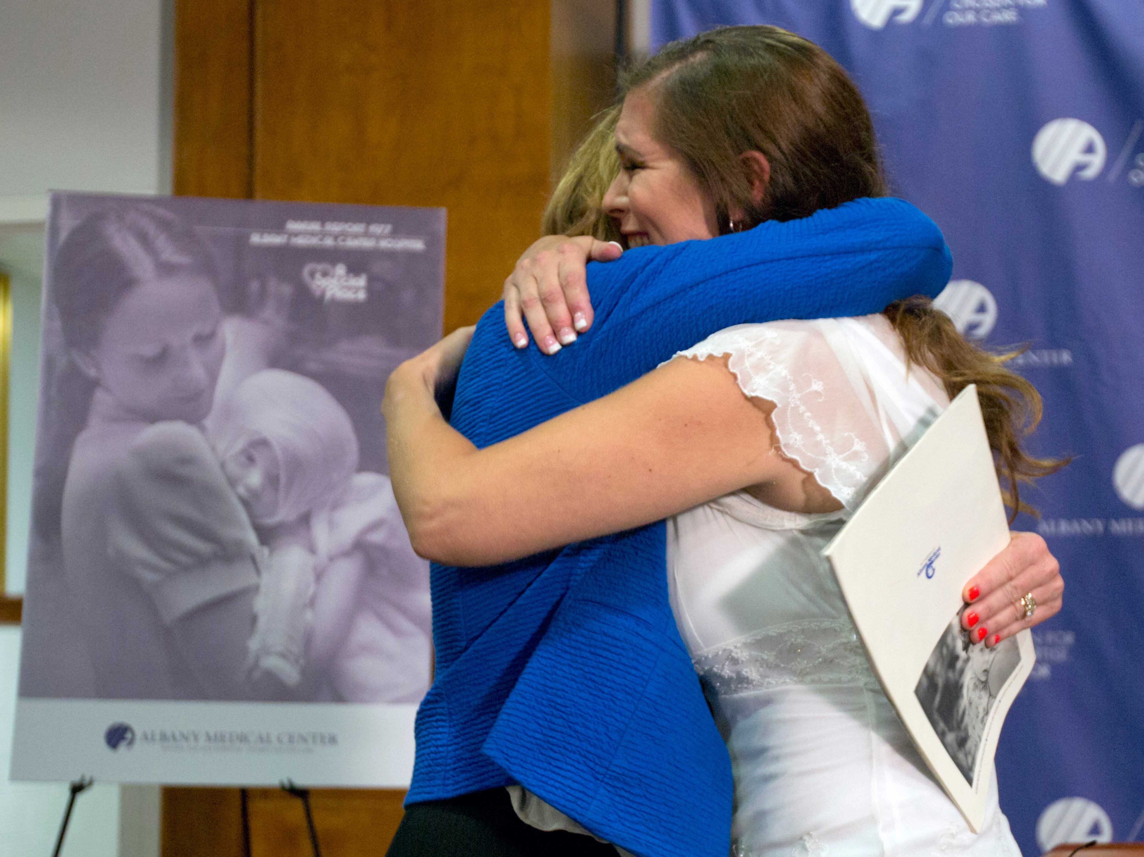Nurse Susan Berger, left, and Amanda Scarpinati hug during a news conference at Albany Medical Center on Sept. 29, 2015, in Albany, N.Y.