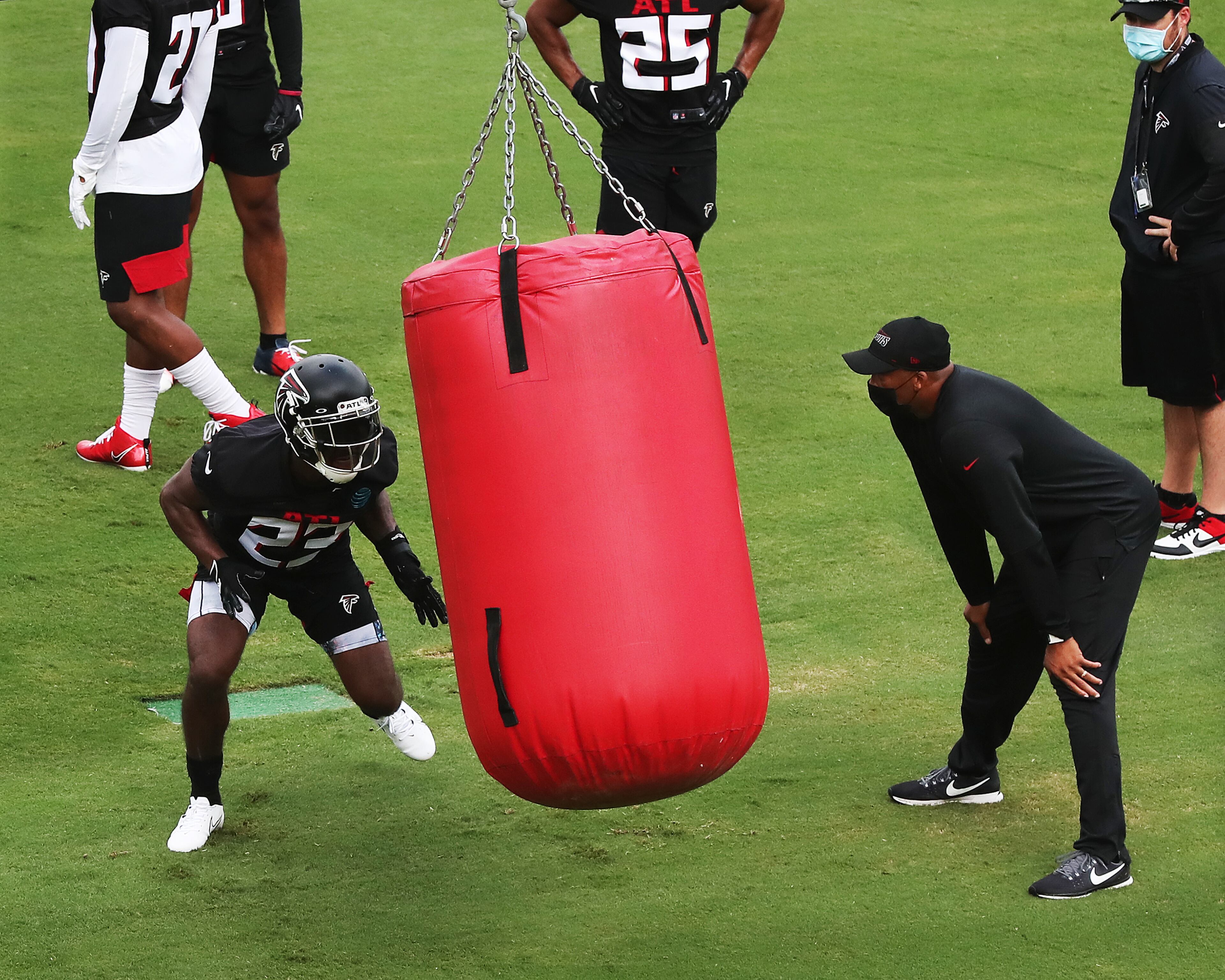 Falcons running back Brian Hill hits a dummy bag while running a blocking drill during training camp on Saturday, August 15, 2020 in Flowery Branch. Curtis Compton ccompton@ajc.com