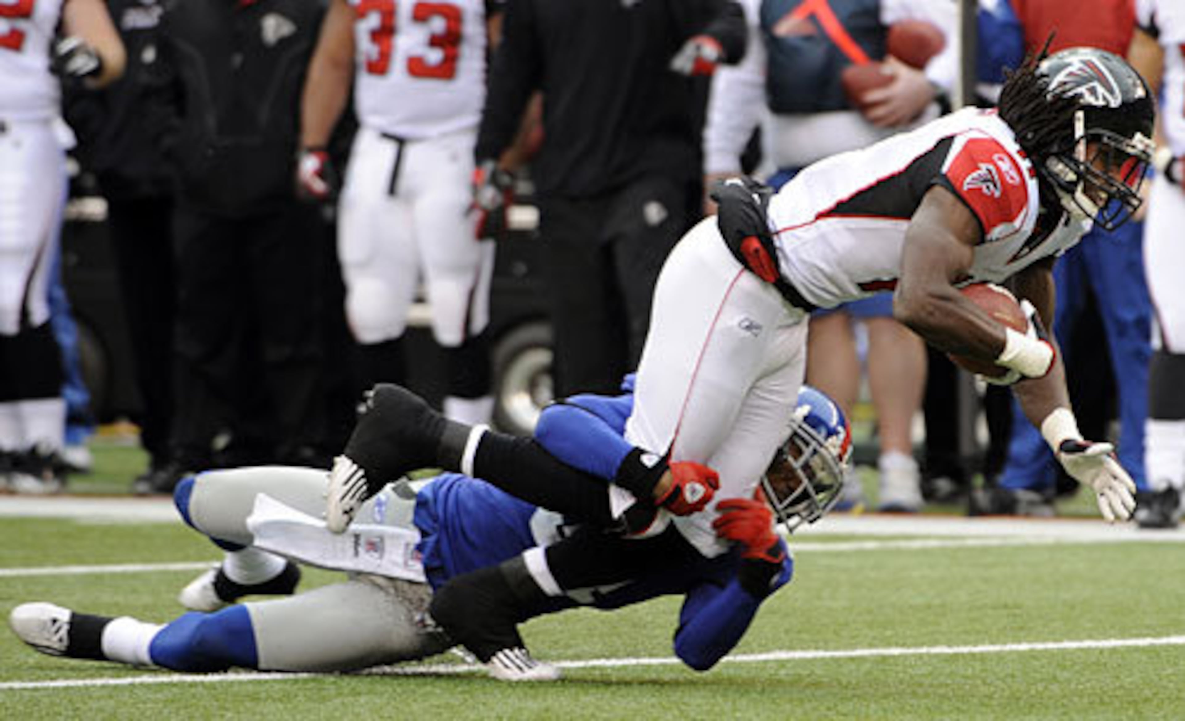Giants cornerback Aaron Ross (31) tackles Atlanta Falcons wide receiver Julio Jones (11) during the first half.