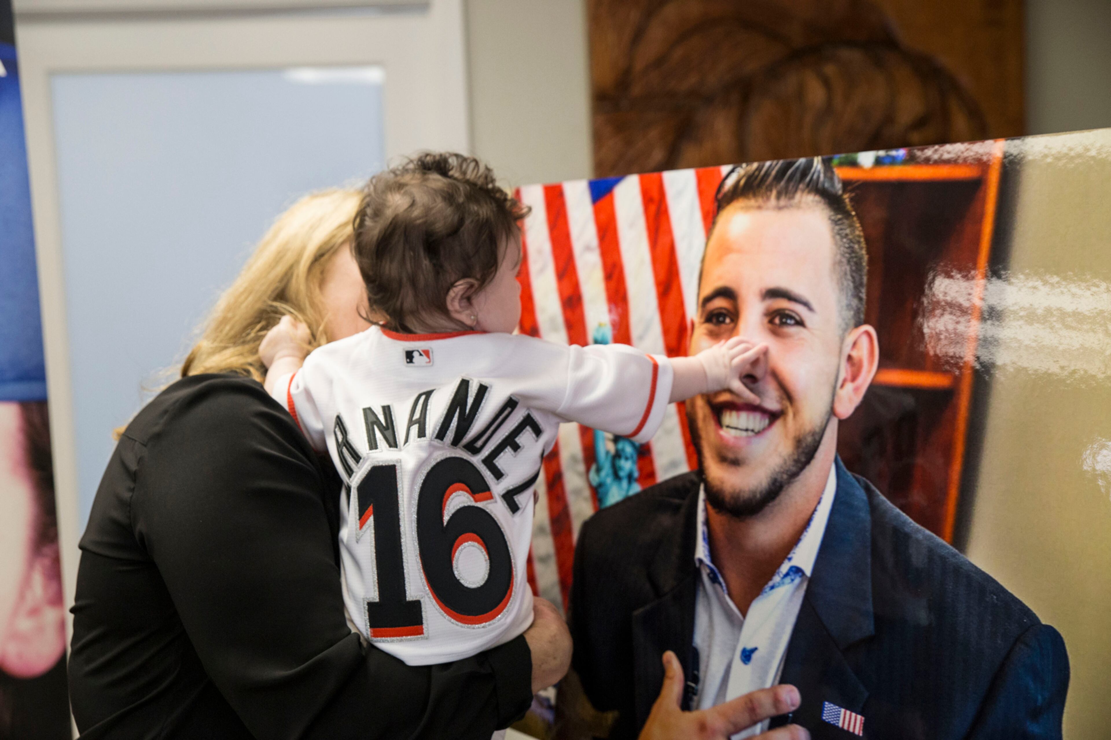 Penelope Fernandez touches a portrait of her father during his birthday commemoration at Kiwanis of Little Havana Monday, July 31, 2017 in Miami. (Sebastian Ballestas/Miami Herald/TNS)