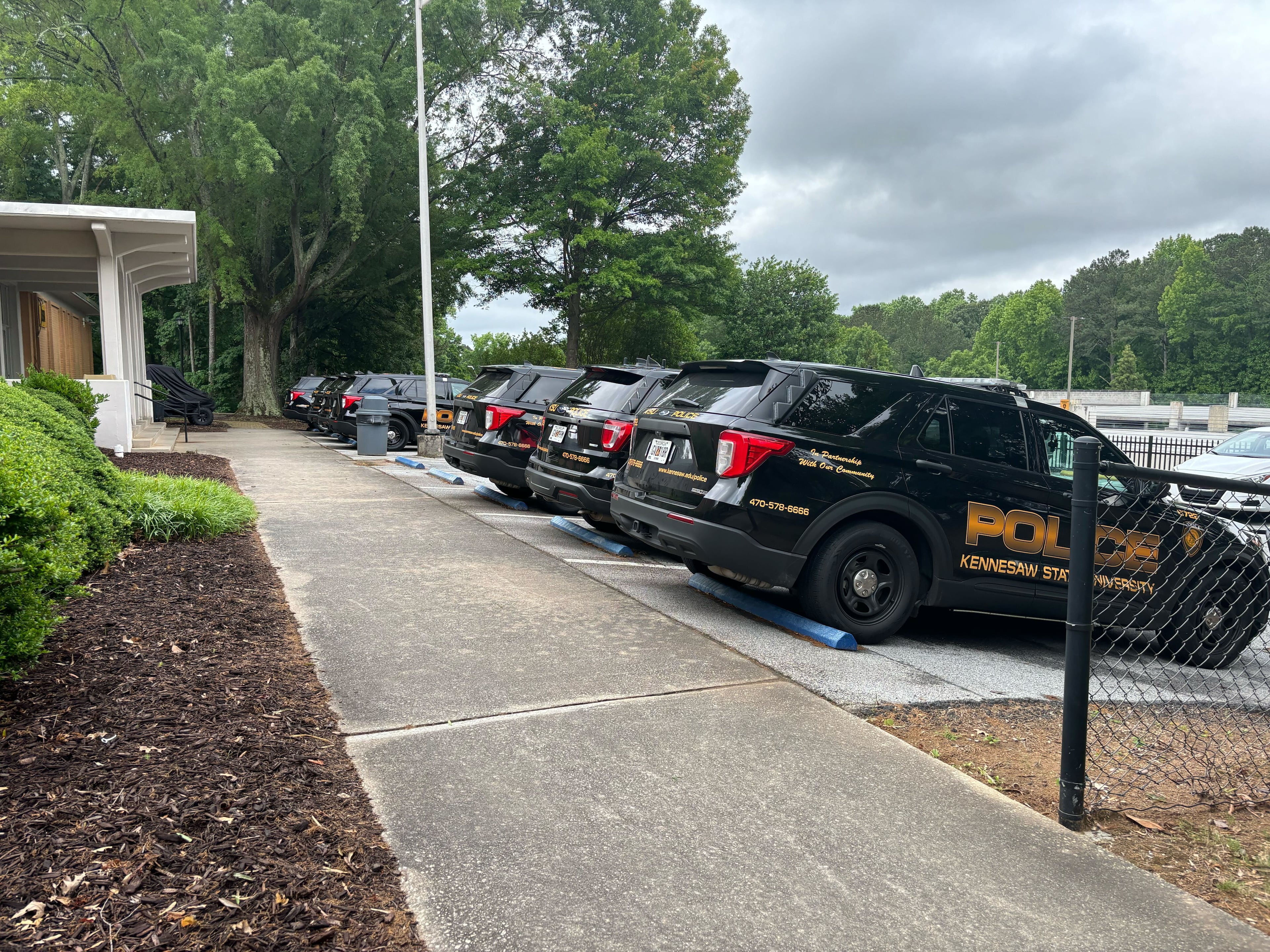 Several Kennesaw State University police patrol vehicles are seen in the university's department of public safety parking lot Sunday morning.