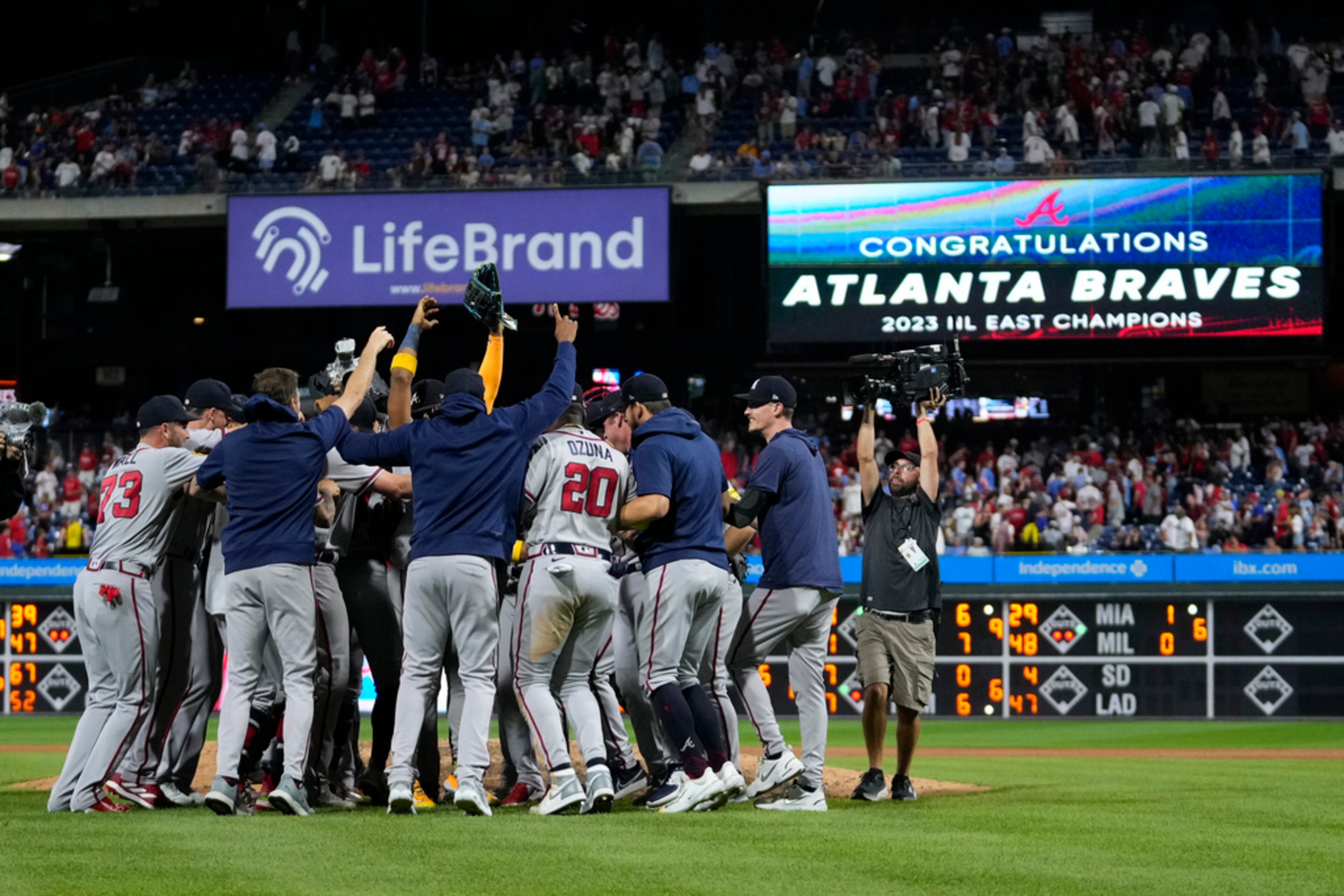 Atlanta Braves players and coaches celebrate after clinching their sixth consecutive NL East title by defeating the Philadelphia Phillies in a baseball game, Wednesday, Sept. 13, 2023, in Philadelphia. (AP Photo/Matt Slocum)