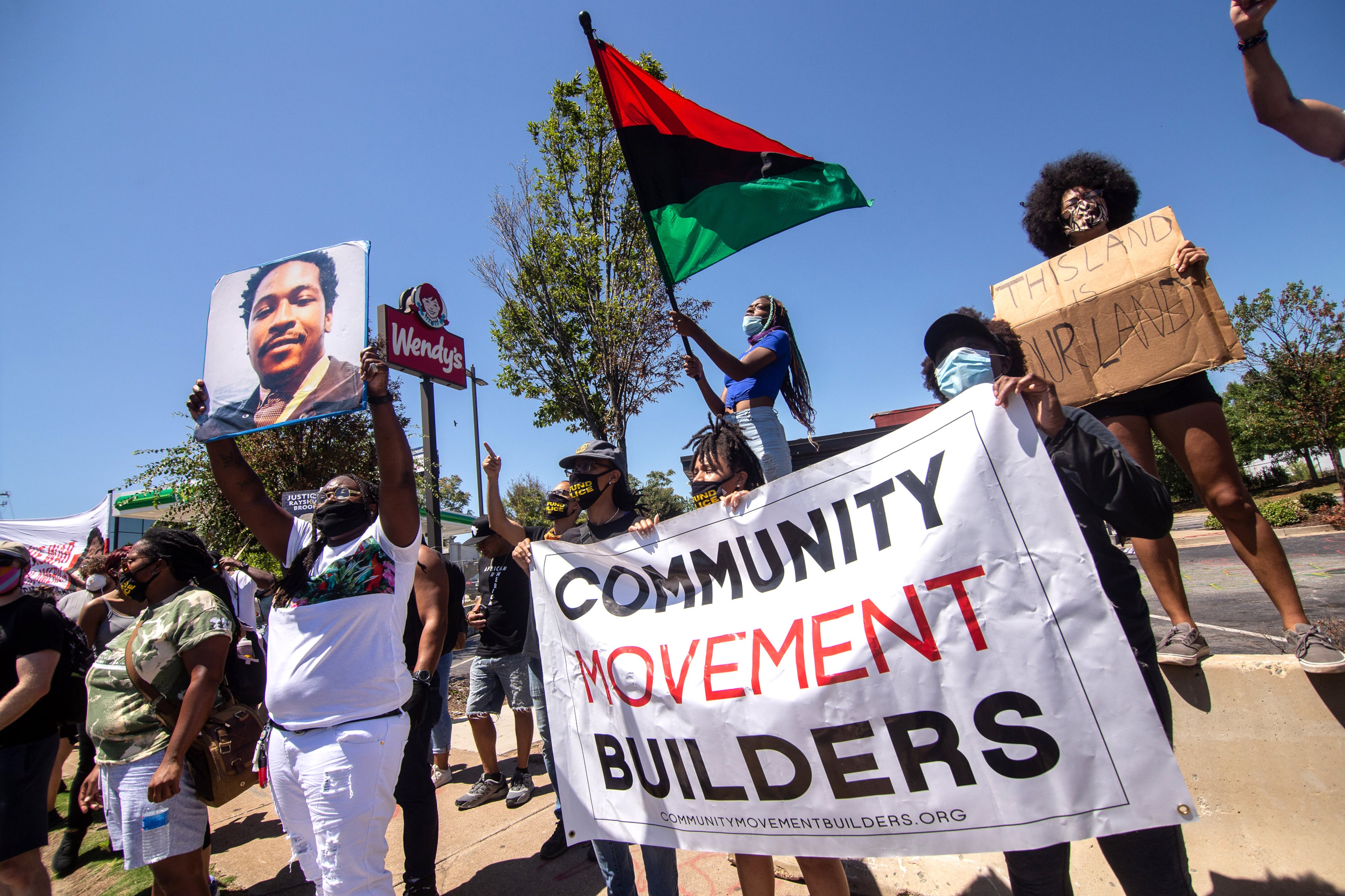 Protesters holds up a sign during the 'Take Back the Wendy's' March & Rally on University Avenue in Atlanta on Saturday, July 11, 2020. The march started at the Community Movement Builders community house and ended at the Wendy's. STEVE SCHAEFER FOR THE ATLANTA JOURNAL-CONSTITUTION