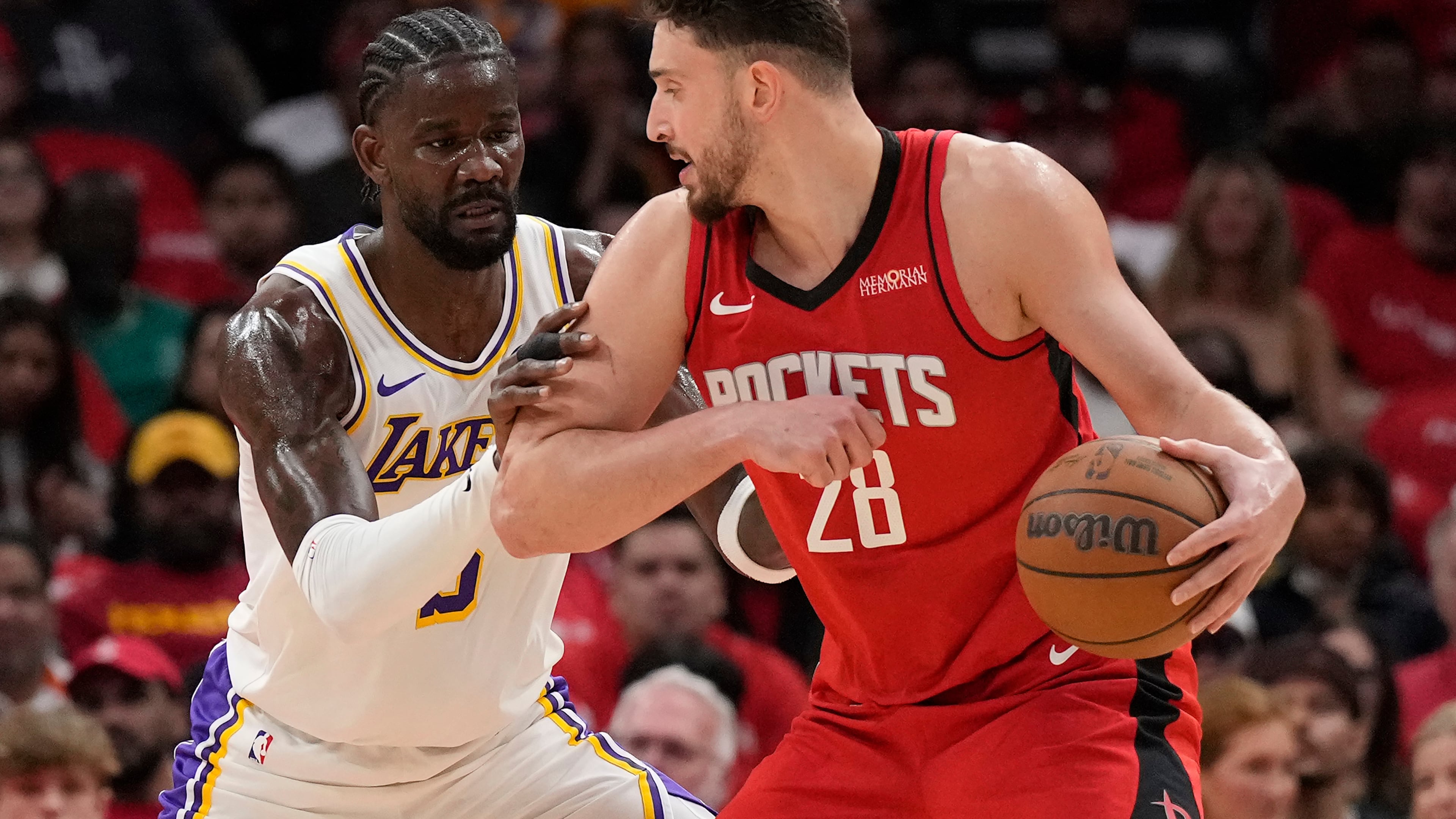 Houston Rockets center Alperen Sengun (28) controls the ball against Los Angeles Lakers center Deandre Ayton (5) during the first half in Game 4 of a first-round NBA basketball playoffs series, Sunday, April 26, 2026, in Houston. (AP Photo/Karen Warren)