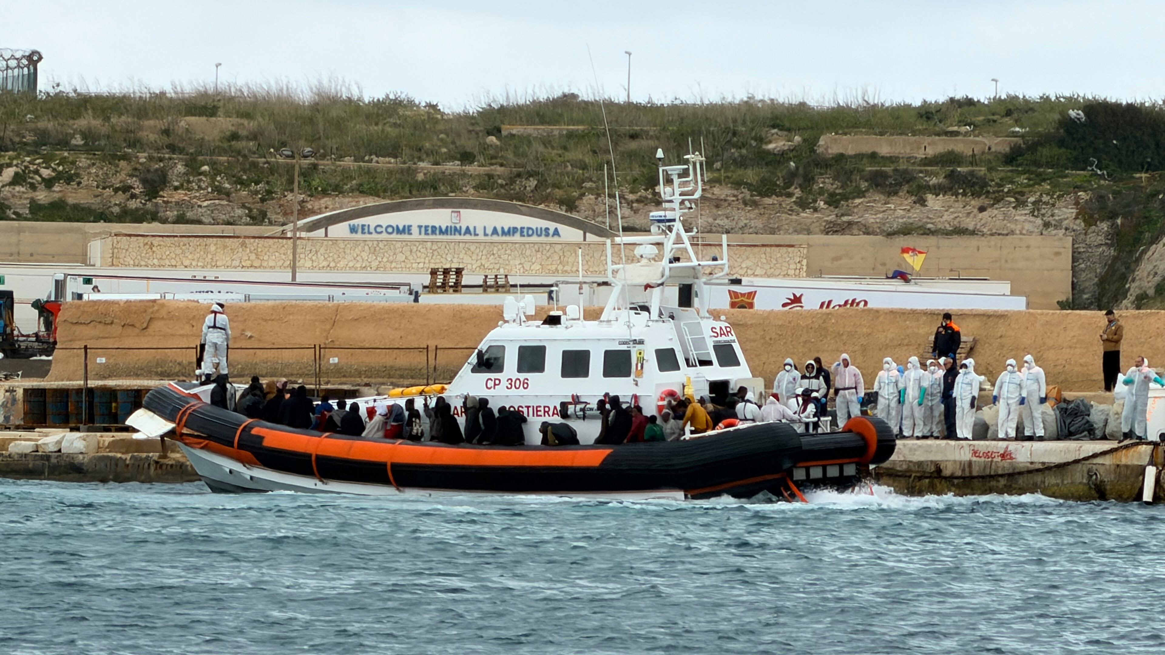 In this photo provided by Mediterranea Saving Humans, an Italian Coast Guard rescue boat at dock in the southern Italian island of Lampedusa, disembarks survivors and bodies rescued from a dinghy filled with migrants at about 80 nautical miles from the island of Lampedusa, Italy, Wednesday, April 1, 2026. (Mediterranea Saving Humans via AP)