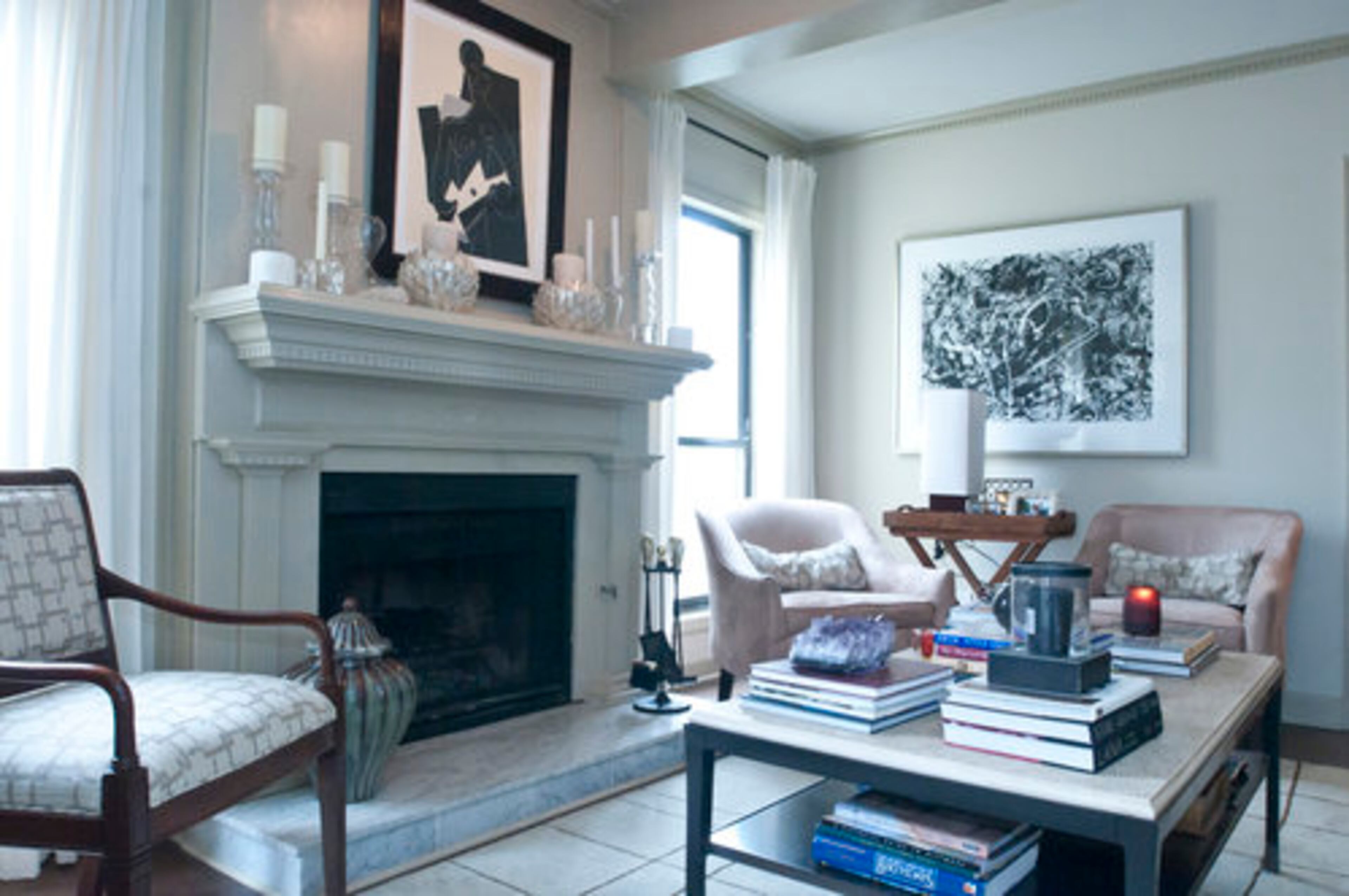 Among the touches in Bill Mohr's home is a French lithograph framed and purchased from Brooks and Black at Atlanta Decorative Arts Center. The ceramic artichoke candle holders on the fireplace mantel are from Jordon Spencer and the sofa and end table by the sofa are from Duralee, both at ADAC. The two tub chairs are from Storehouse and the antique Regency chair was handed down from his family. The chair was recovered in a modern geometric pattern