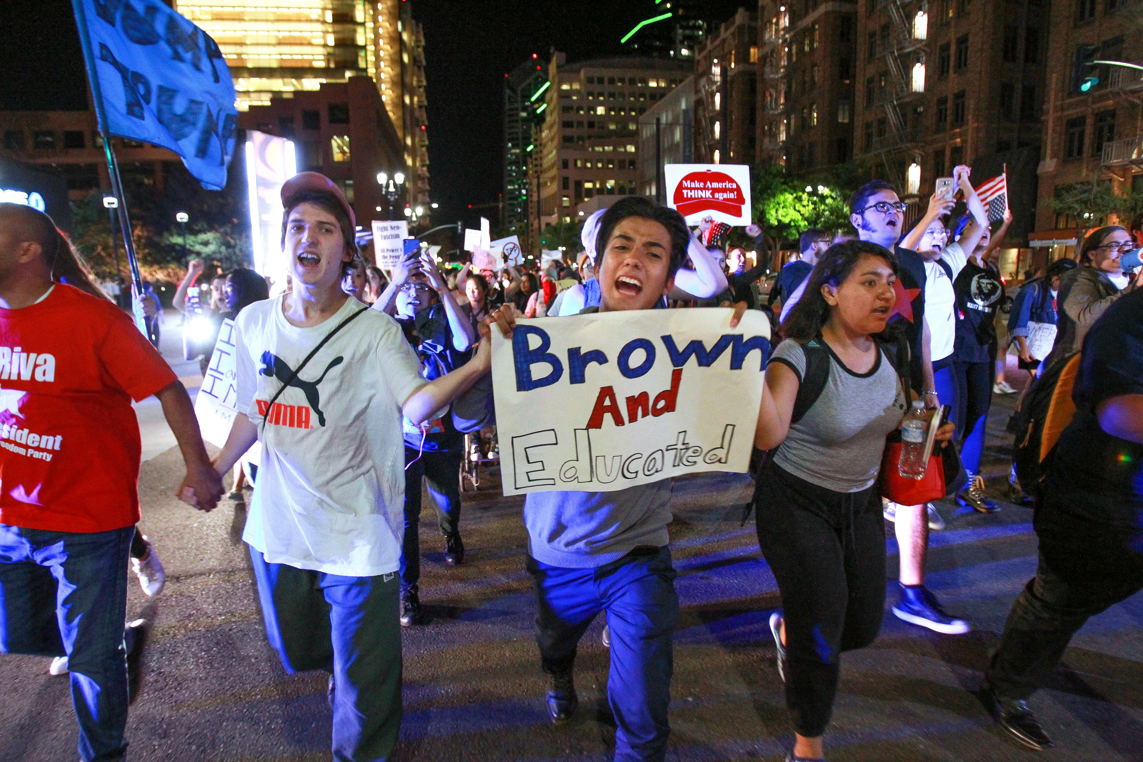 Abraham Barragan, 18, center, joins others as they march down Broadway, Wednesday, Nov. 9, 2016, in downtown San Diego, during a protest in opposition of Donald Trump's presidential election victory. (Hayne Palmour IV/The San Diego Union-Tribune via AP)