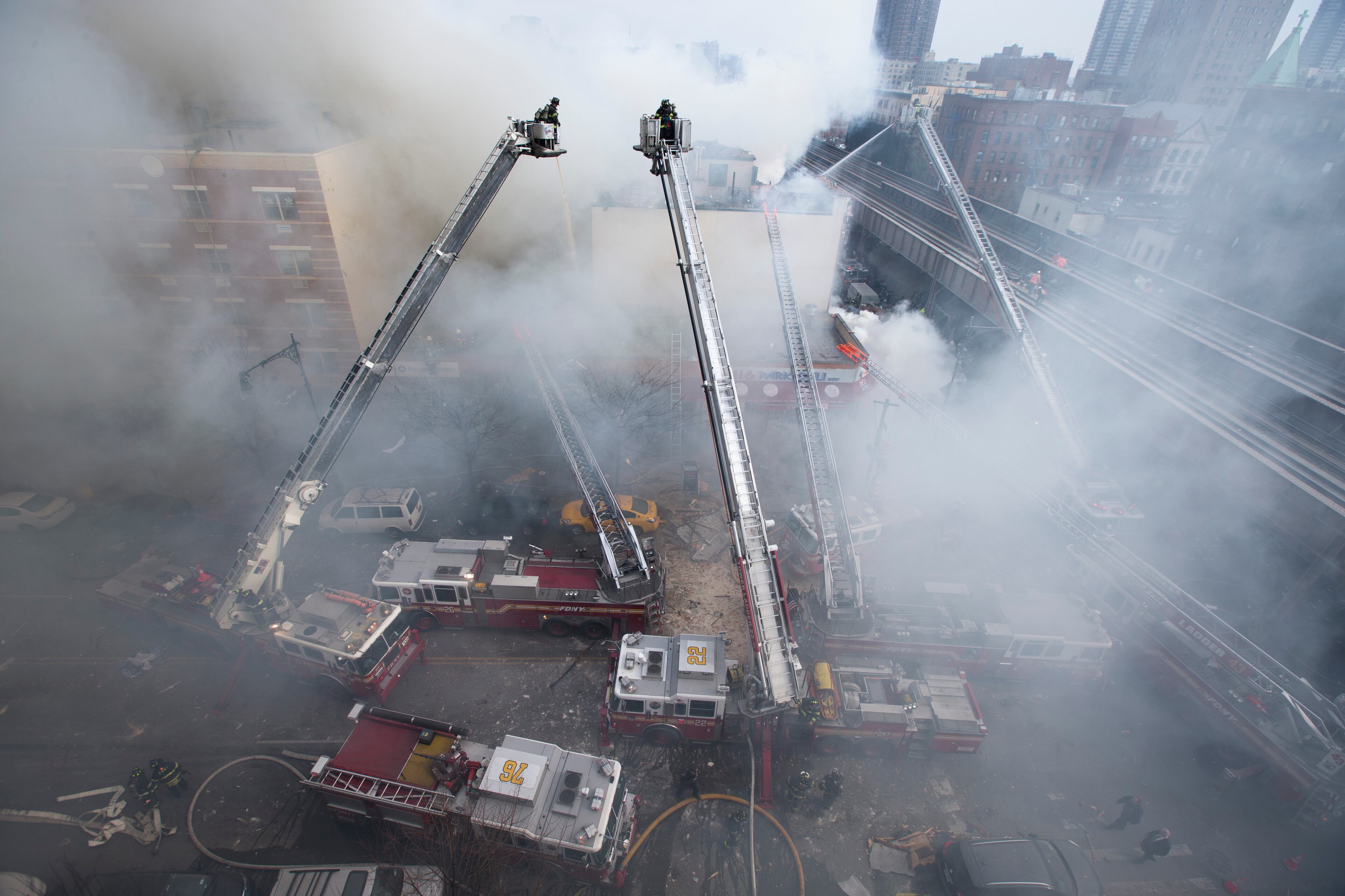 Firefighters respond to an explosion that leveled two apartment buildings in the East Harlem neighborhood of New York, Wednesday, March 12, 2014. Con Edison spokesman Bob McGee says a resident from a building adjacent to the two that collapsed reported that he smelled gas inside his apartment, but thought the odor could be coming from outside. (AP Photo/John Minchillo)