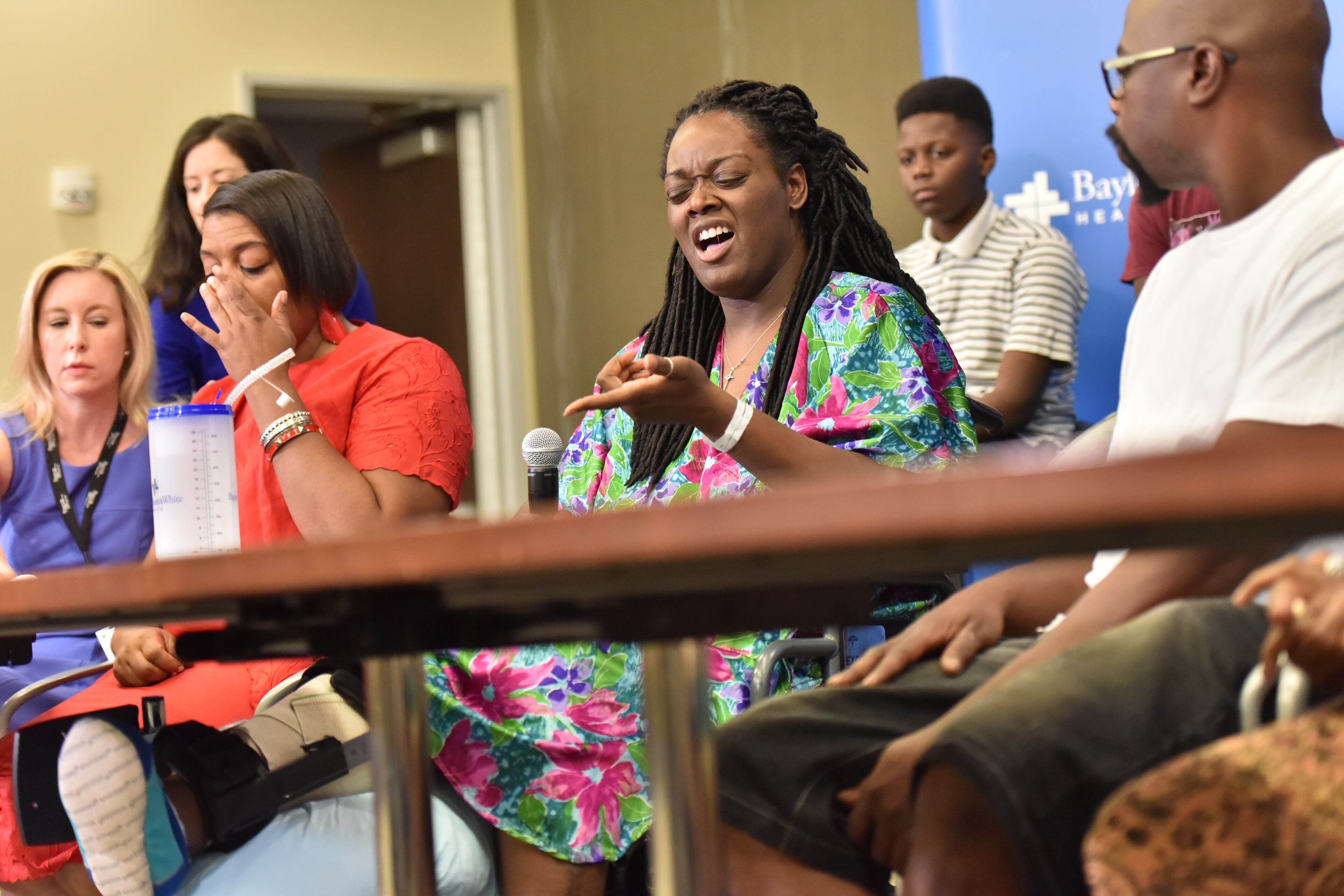 July 10, 2016 Dallas, Texas - Dallas shooting survivor Shetamia Taylor reacts as she recalls during a press conference at Baylor University Medical Center on Sunday, July 10, 2016. Shetamia Taylor, 37, risked her life to protect her 15-year-old son as chaos broke out in Dallas Thursday night when a sniper opened fire after an otherwise peaceful protest, killing five law enforcement officers. HYOSUB SHIN / HSHIN@AJC.COM