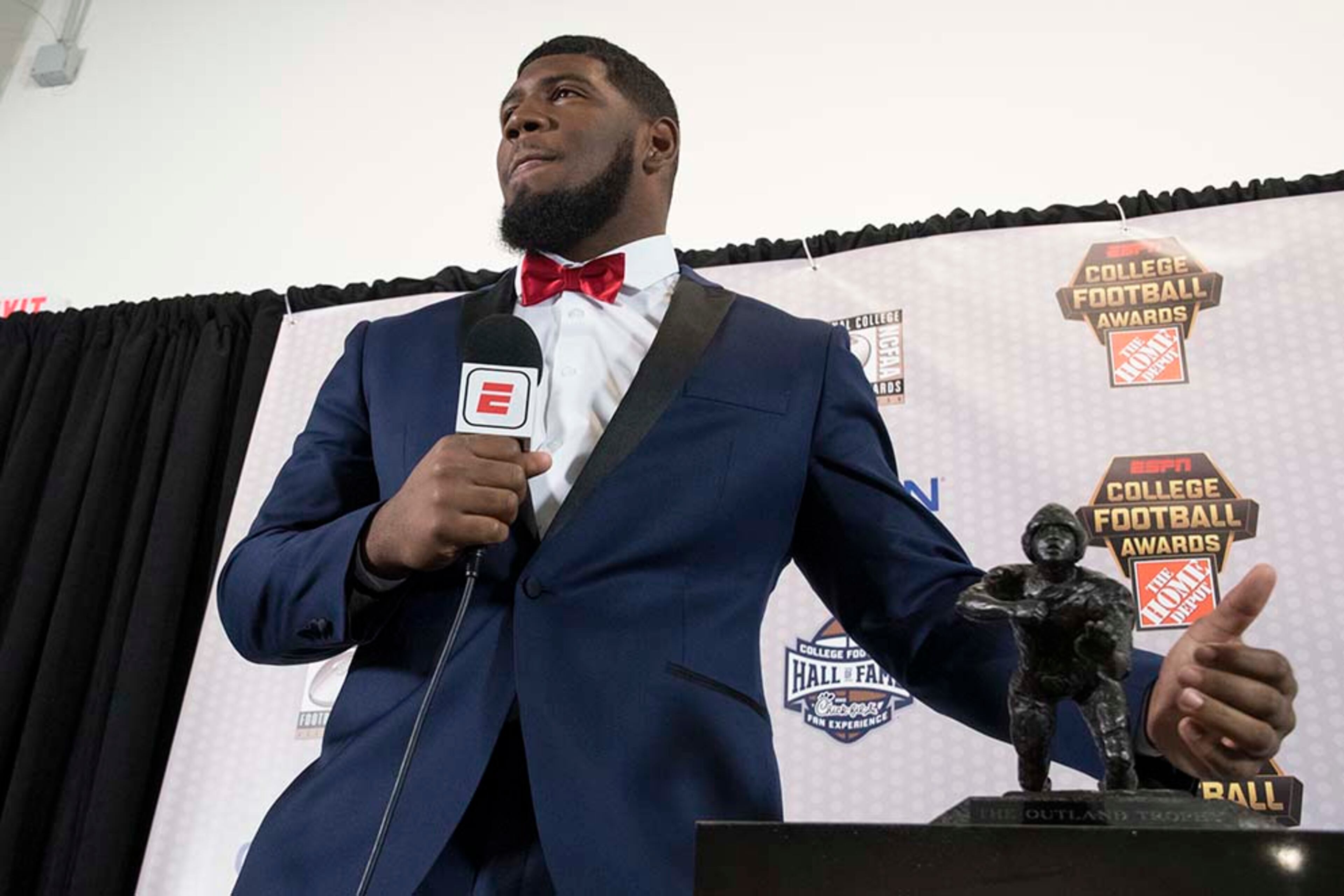 Houston defensive tackle Ed Oliver, winner of the Outland Trophy for outstanding interior lineman, stands with the trophy while taking questions during the College Football Awards show at the College Football Hall of Fame, Thursday, Dec. 7, 2017, in Atlanta.