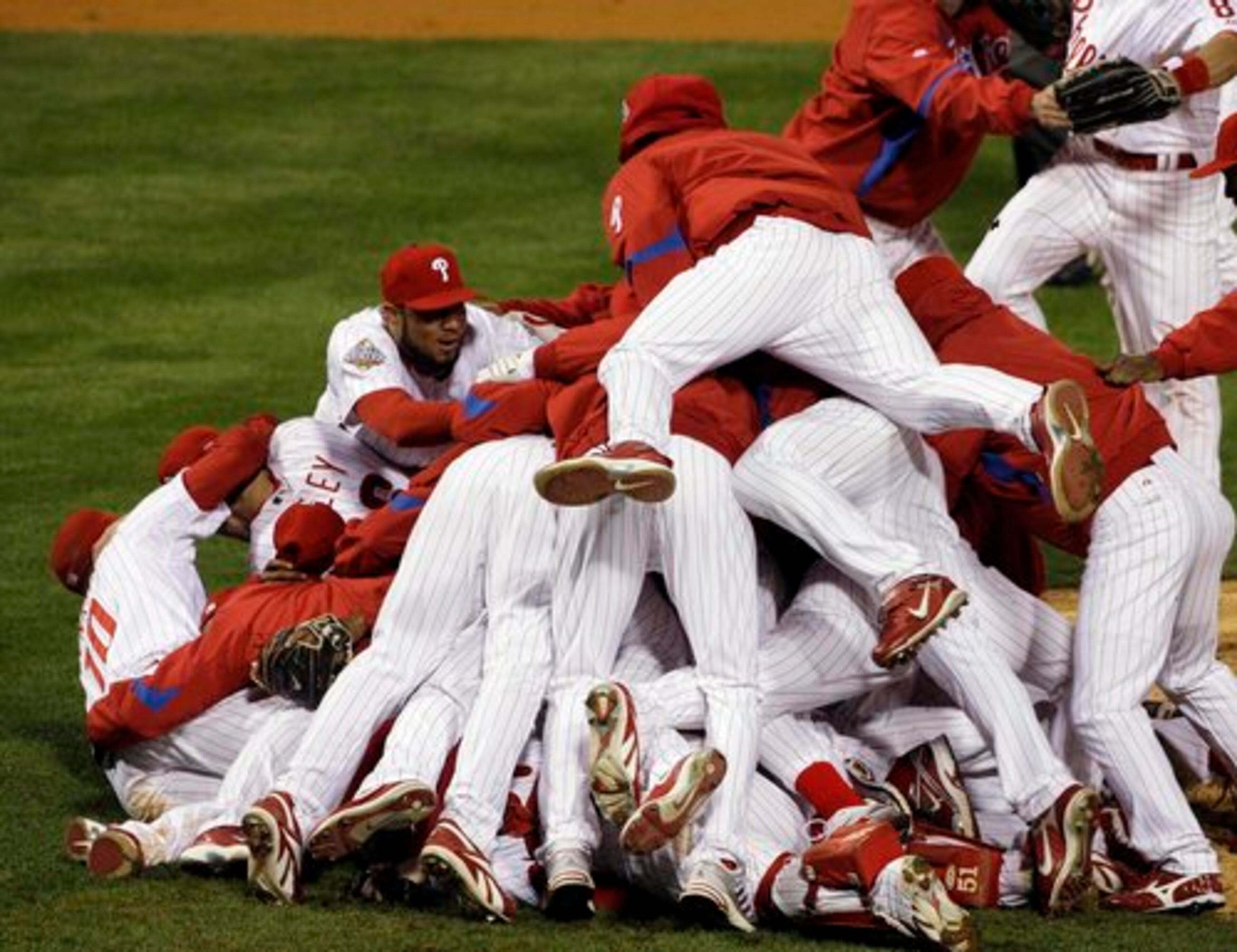 Phillies players pile up on the mound after beating the Ray in Game 5 to win the World Series.