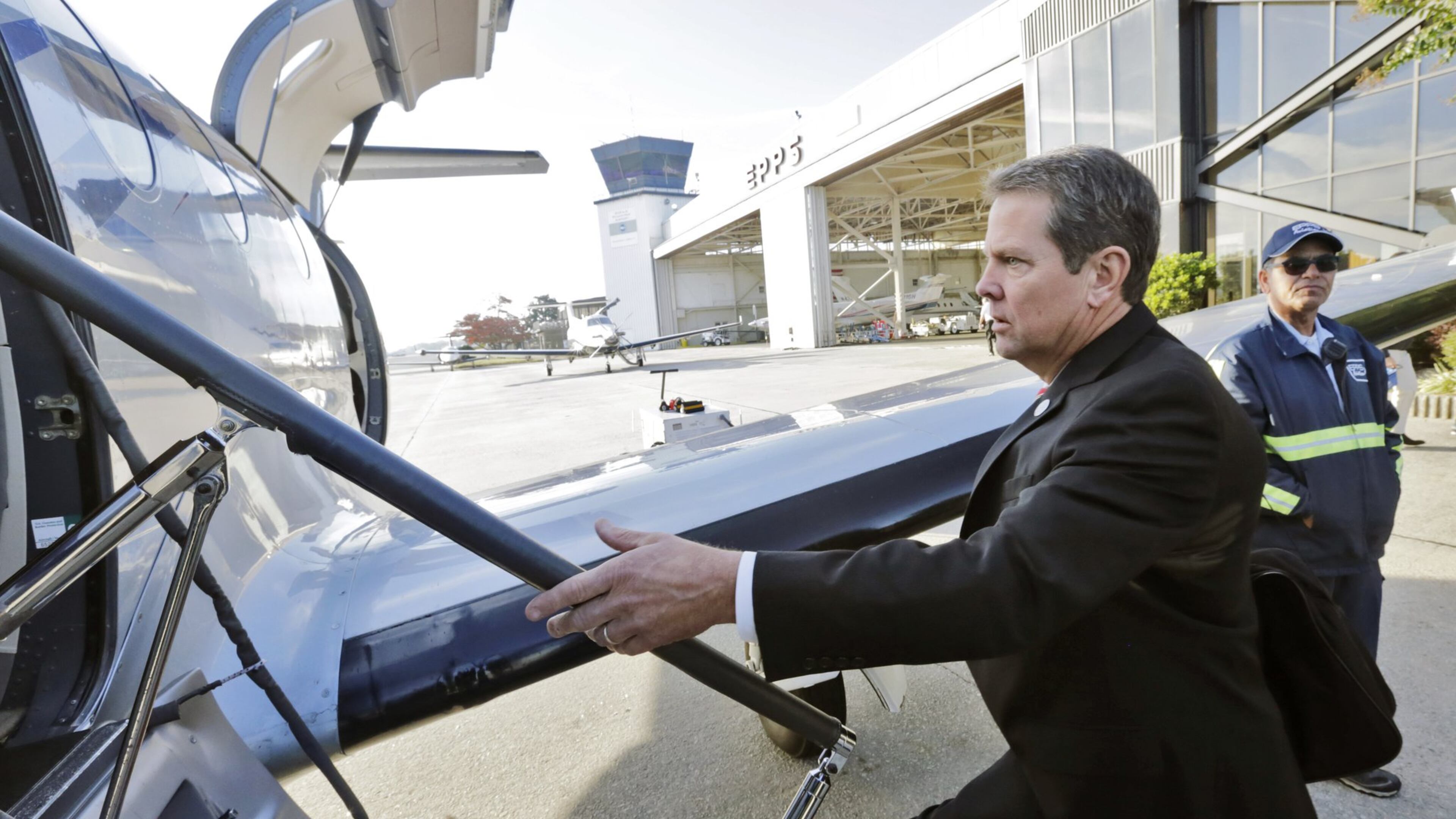 Georgia Secretary of State Brian Kemp boards a plane Monday morning at Peachtree-DeKalb Airport, kicking off a statewide tour ahead Tuesday’s Election Day. BOB ANDRES /BANDRES@AJC.COM