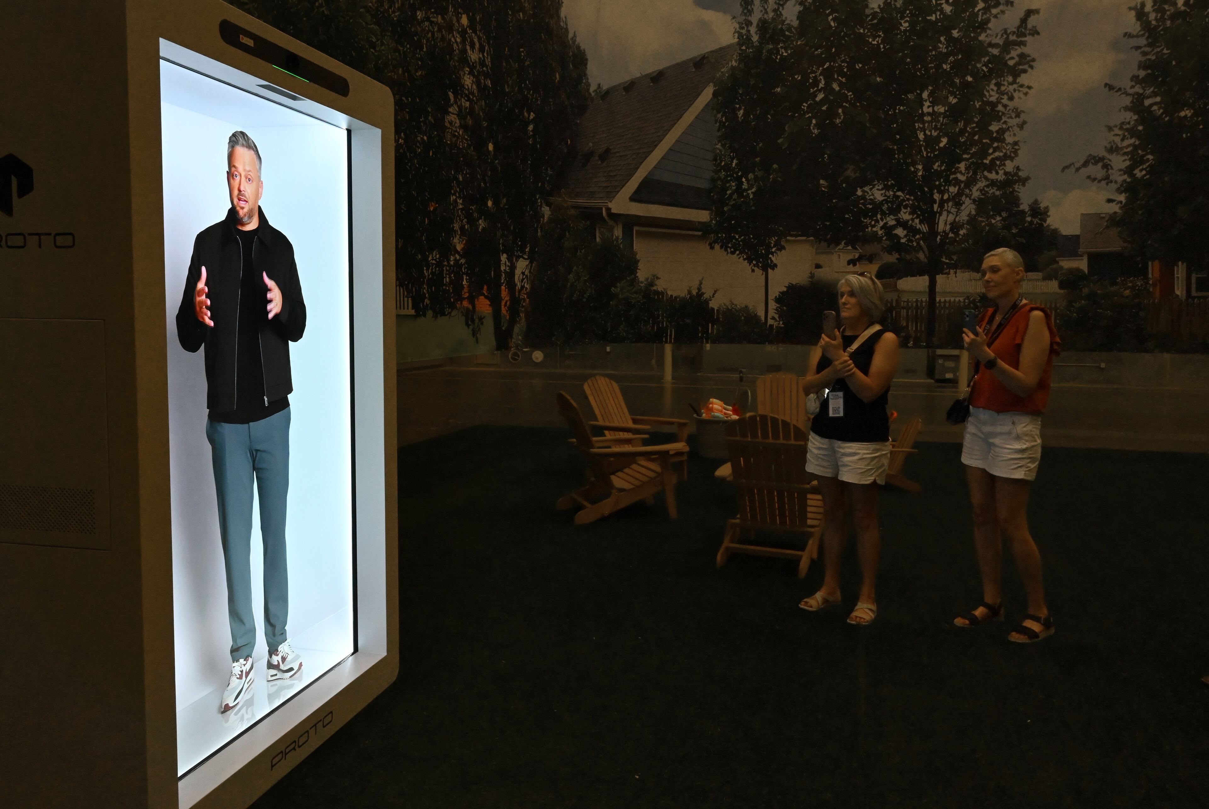 Studio guests watch a hologram video presentation from comedian Nate Bargatze on the set of “The Breadwinner,” which starred Bargatze and was filmed at Trilith Studios in Fayetteville. (Hyosub Shin/AJC)