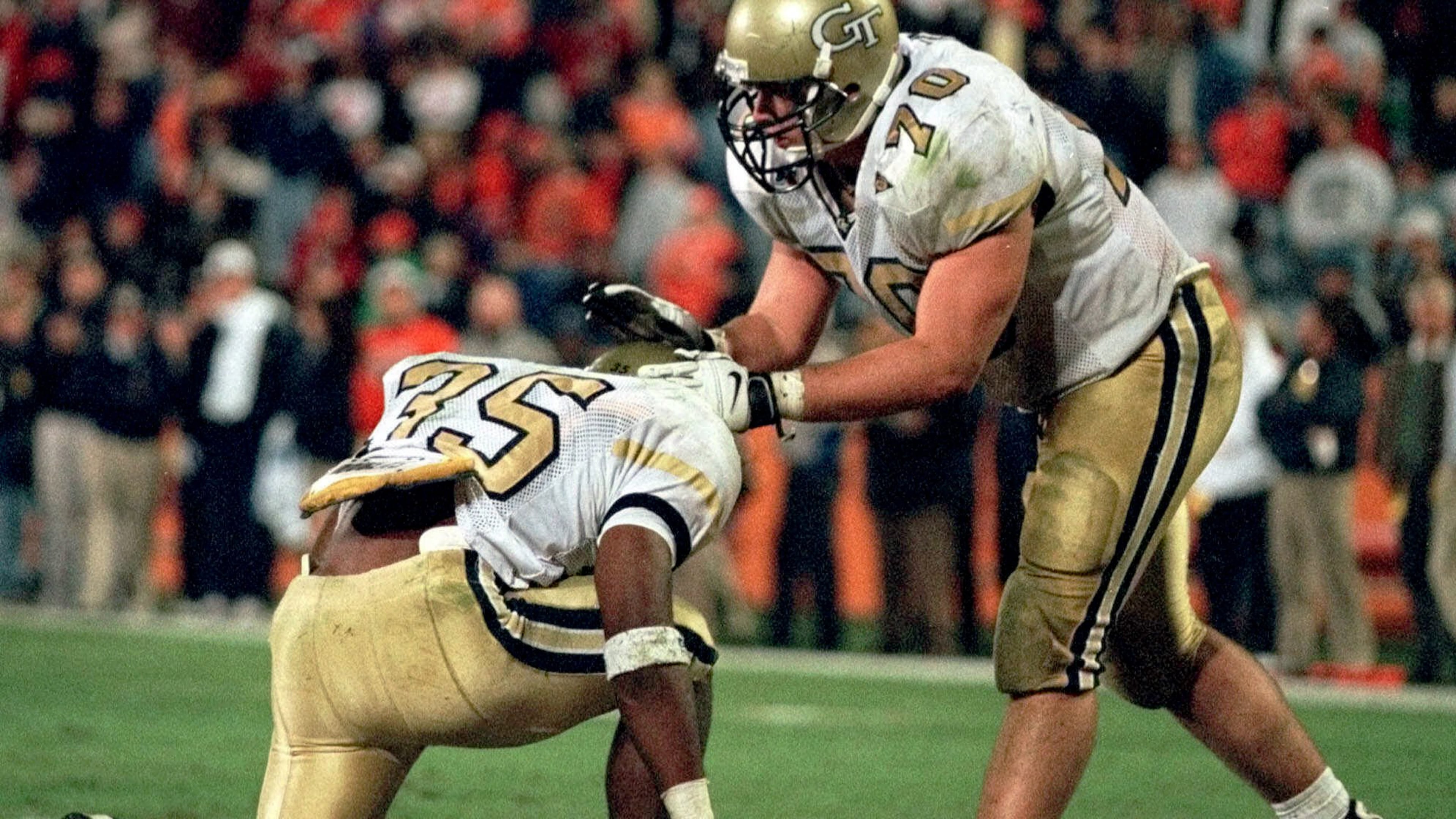 Georgia Tech's Joe Burns (35) takes a moment after scoring the winning touchdown against Clemson Thursday, Nov. 12, 1998, as his teammate Brent Key (70) pats him on the helmet at Memorial Stadium in Clemson, S.C. (AP Photo/Patrick Collard)