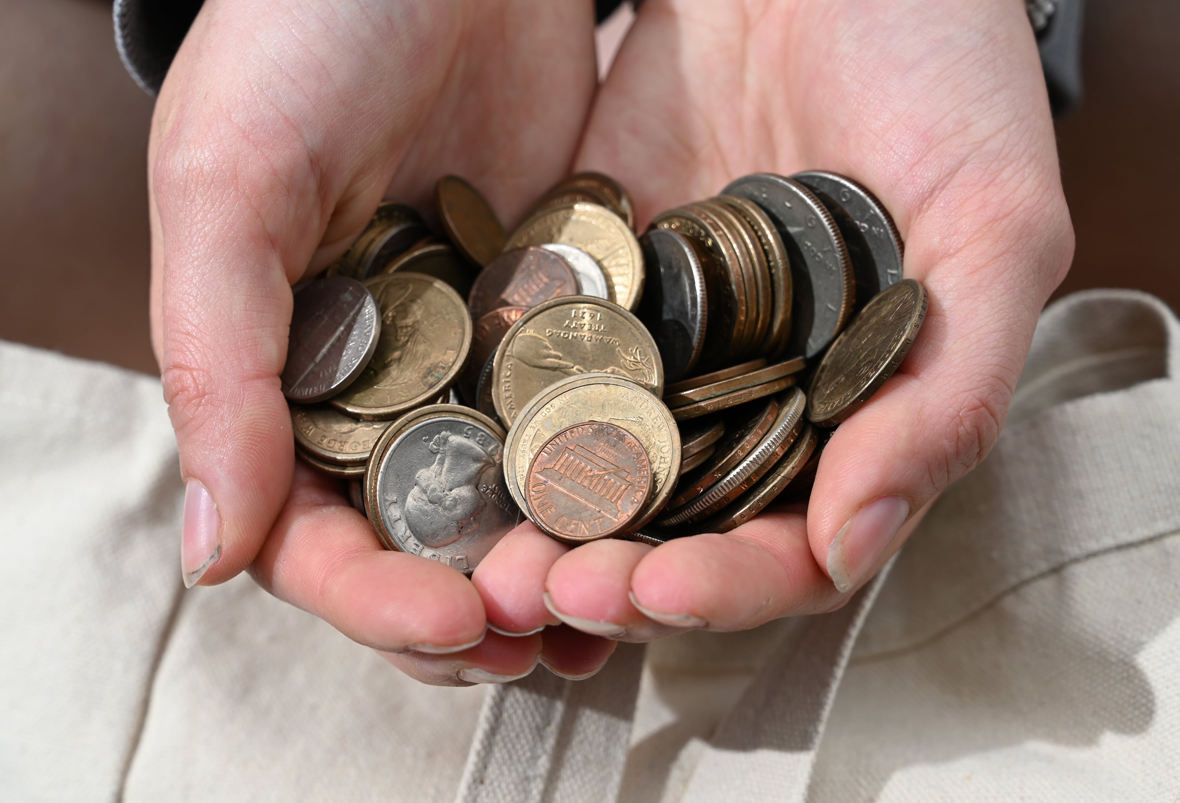 Dream Hain holds coins collected by her father and grandfather that she was able to salvage from her old dorm room. Hain was one of 143 students who lost precious possessions and were forced to move after the April 27 fire. (Hyosub Shin/AJC)