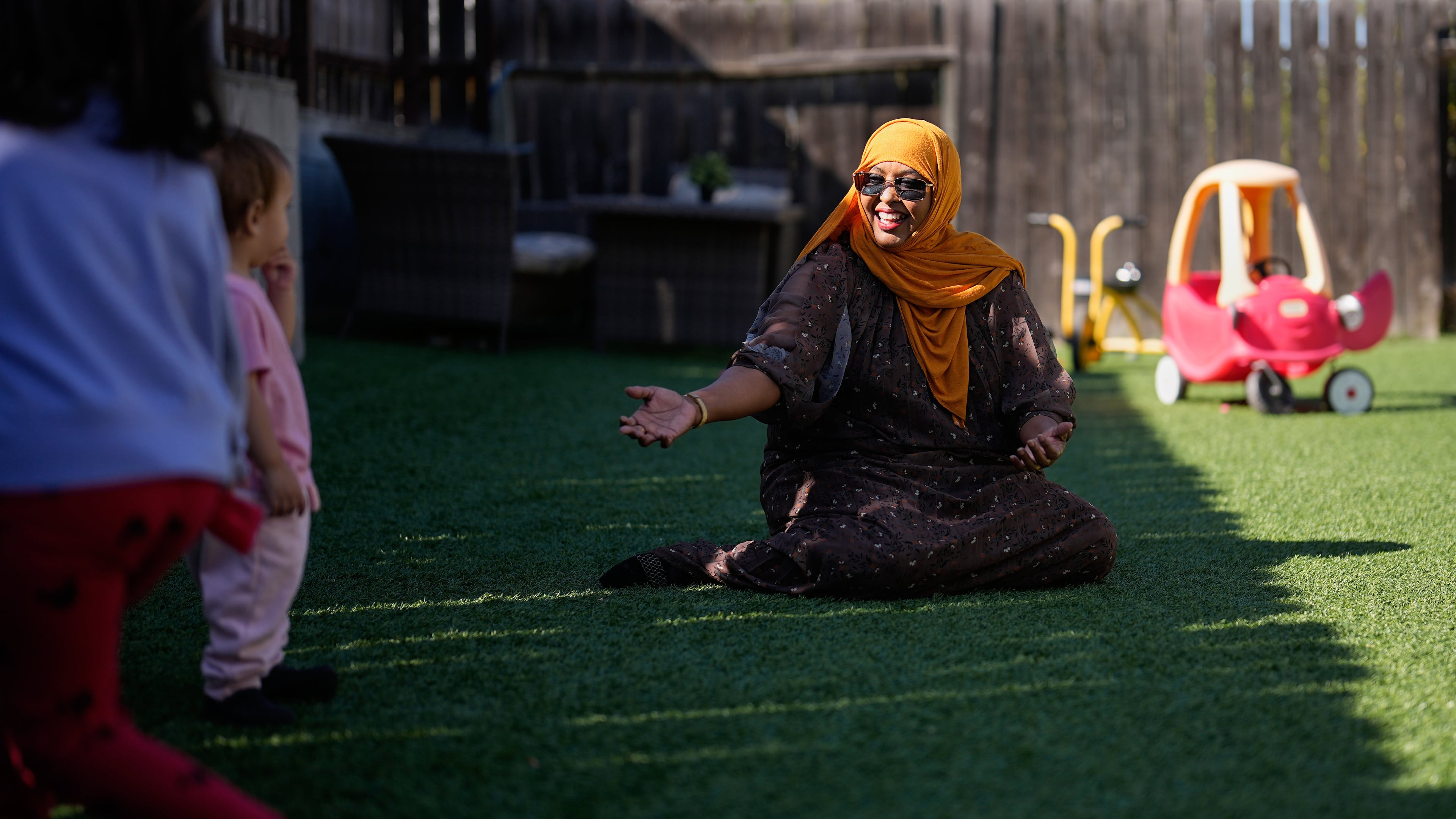 Samsam Khalif plays with children at her home-based child care center Friday, Jan. 30, 2026, in San Diego. (AP Photo/Gregory Bull)