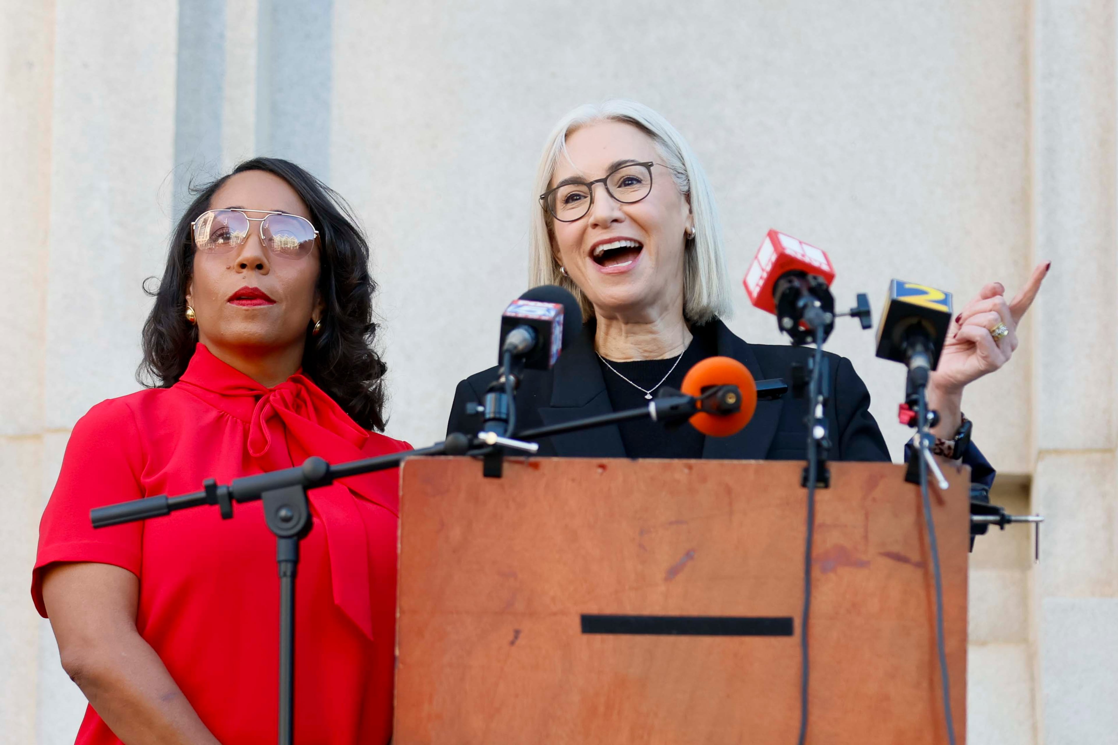 “I understood that when I voted there might be consequences for my actions,” Democratic Commissioner Dana Barrett (right) said as she stood with follow Commissioner Mo Ivory outside Fulton County Superior Court on Wednesday. (Miguel Martinez/AJC)