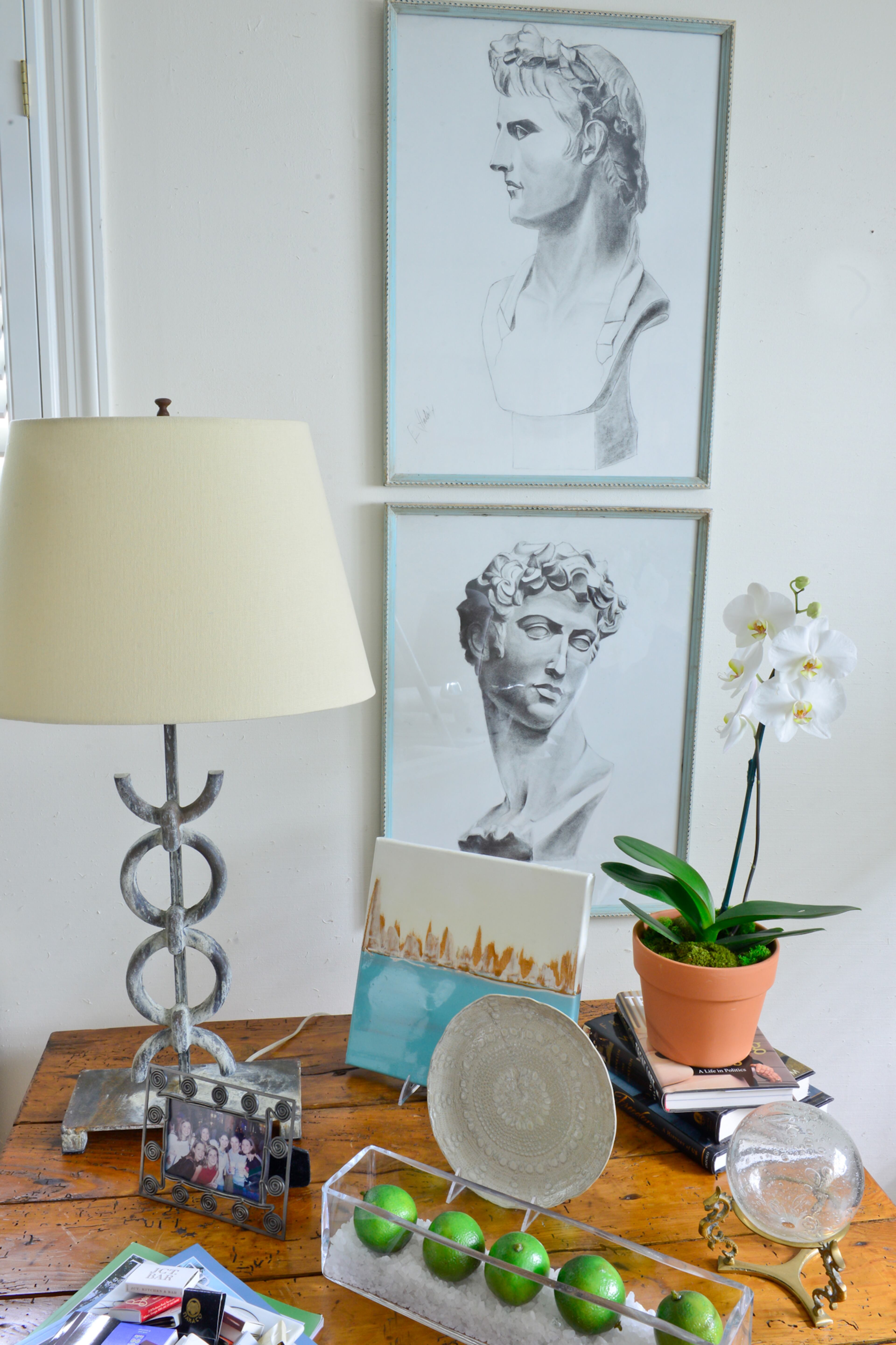 The exposed brick wall in the bonus room originally was the outside of the home. Unique items in the bonus room include two drawings of Roman-style busts, from Kay Fuller Interiors in Albany. The room's gray and blue color palette and linen fabrics create a "beachy" feel, Betsy Clay said.