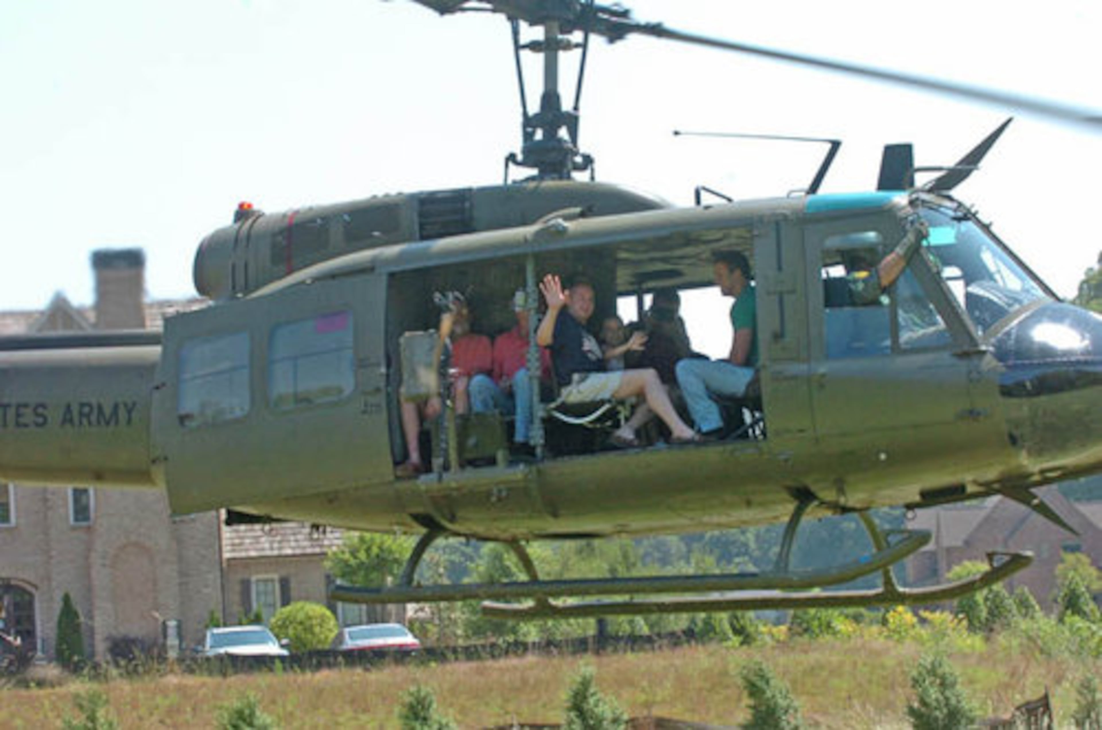 Civilians go for a ride on a UH1-D Huey, which flew in Vietnam missions, after the event.