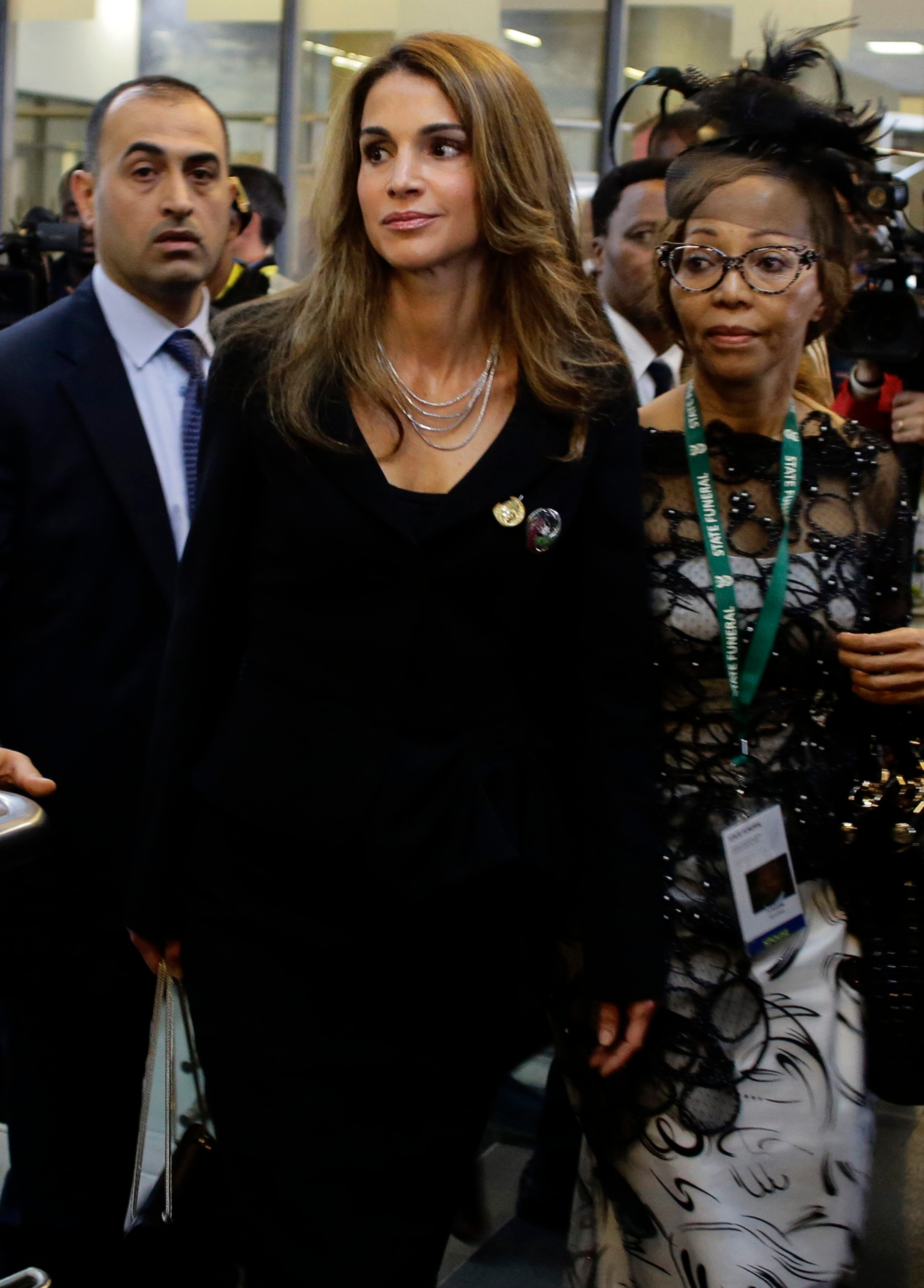 Jordan's Queen Rania (C) arrives for the service for former South African President Nelson Mandela at the First National Bank Stadium, also known as Soccer City, in Johannesburg December 10, 2013. World leaders from U.S. President Barack Obama to Cuba's Raul Castro joined thousands of South Africans to honour Nelson Mandela on Tuesday in a memorial that will celebrate his gift for uniting enemies across political and racial divides. REUTERS/Kevin Coombs (SOUTH AFRICA - Tags: POLITICS OBITUARY ENTERTAINMENT)