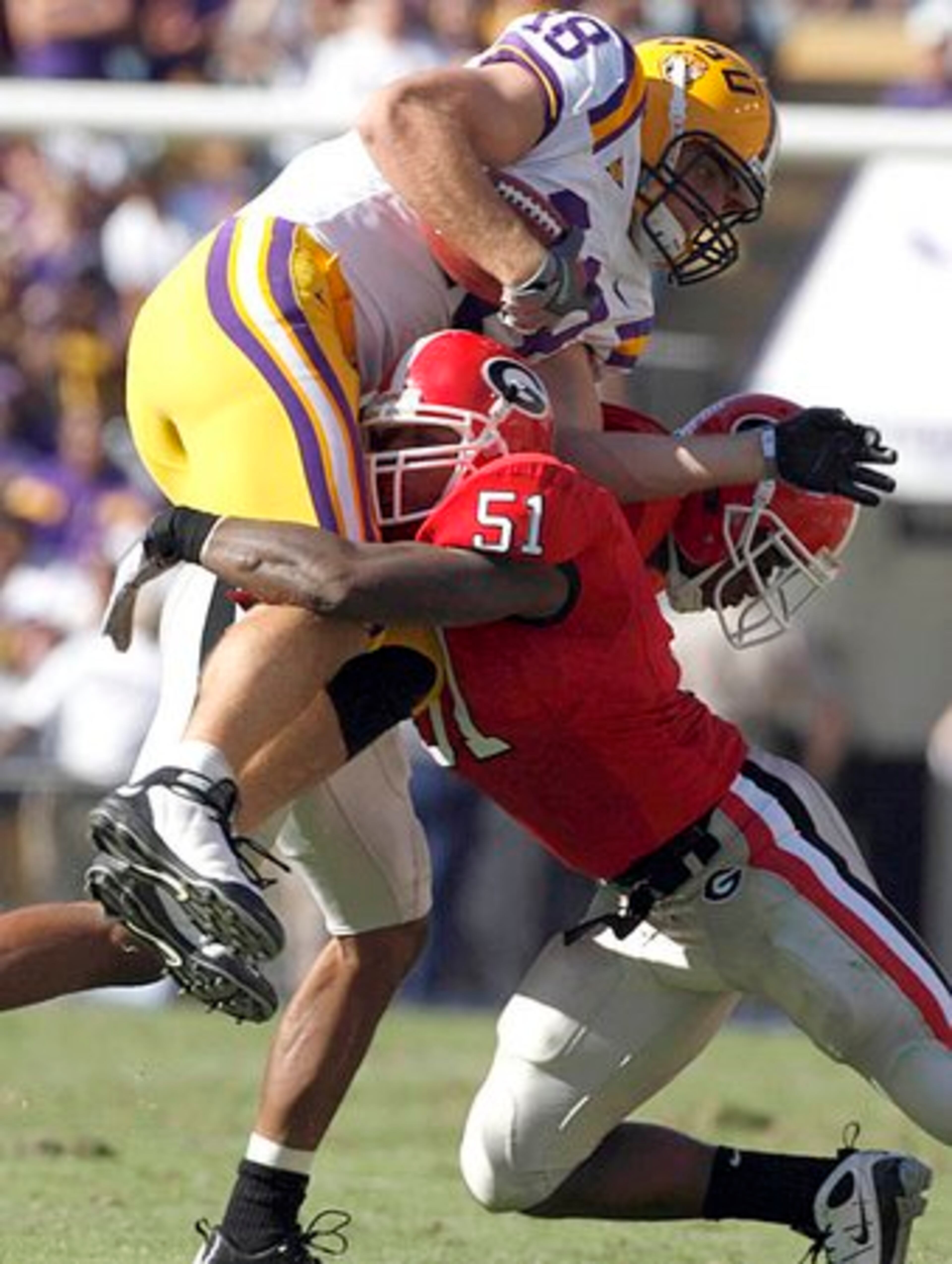 LSU tight end Richard Dickson (18) gets hit after a catch by Georgia linebacker Akeem Dent.