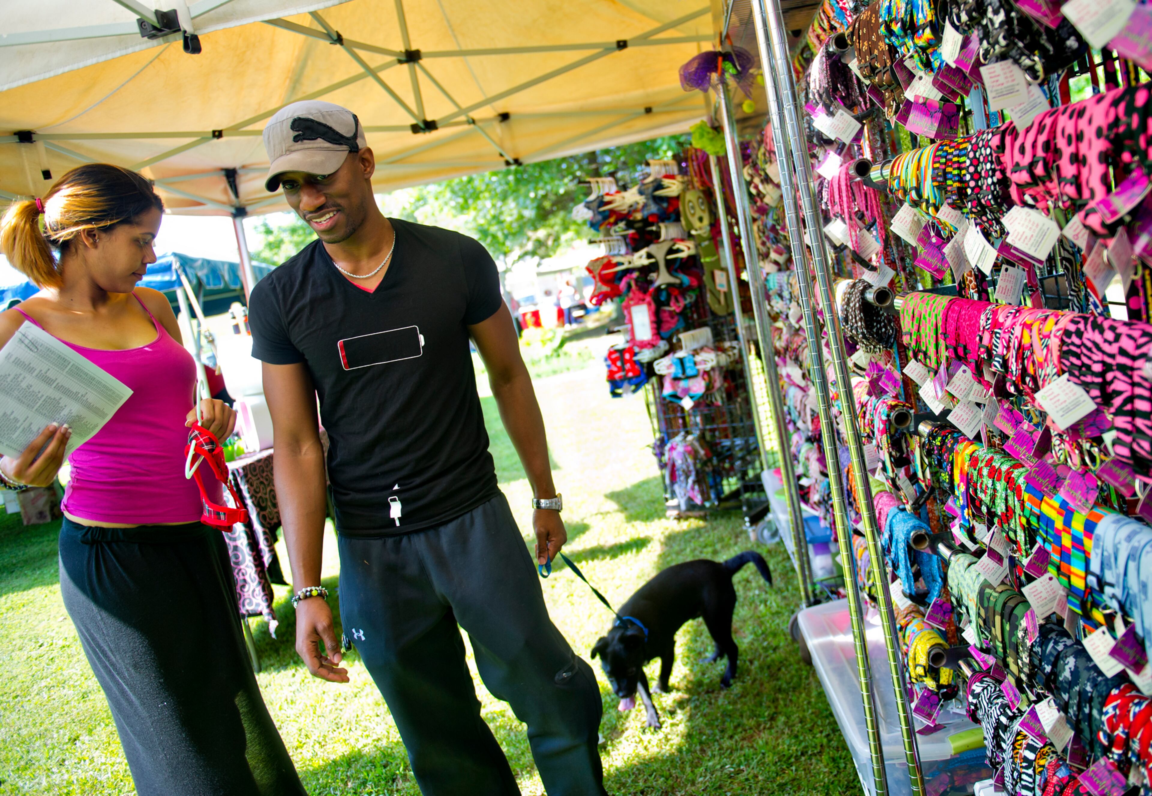 Tammi Douglas (left) and her husband Jason buy a harness for their newly adopted puggle during the Art, Barks & Purrs Arts and Crafts Festival at the Cobb County Animal Control facility in Marietta on Saturday, June 21, 2014. The third annual festival featured 28 different artists and crafters from around the metro Atlanta area, a silent auction as well as an opportunity to adopt dogs and cats. JONATHAN PHILLIPS / SPECIAL