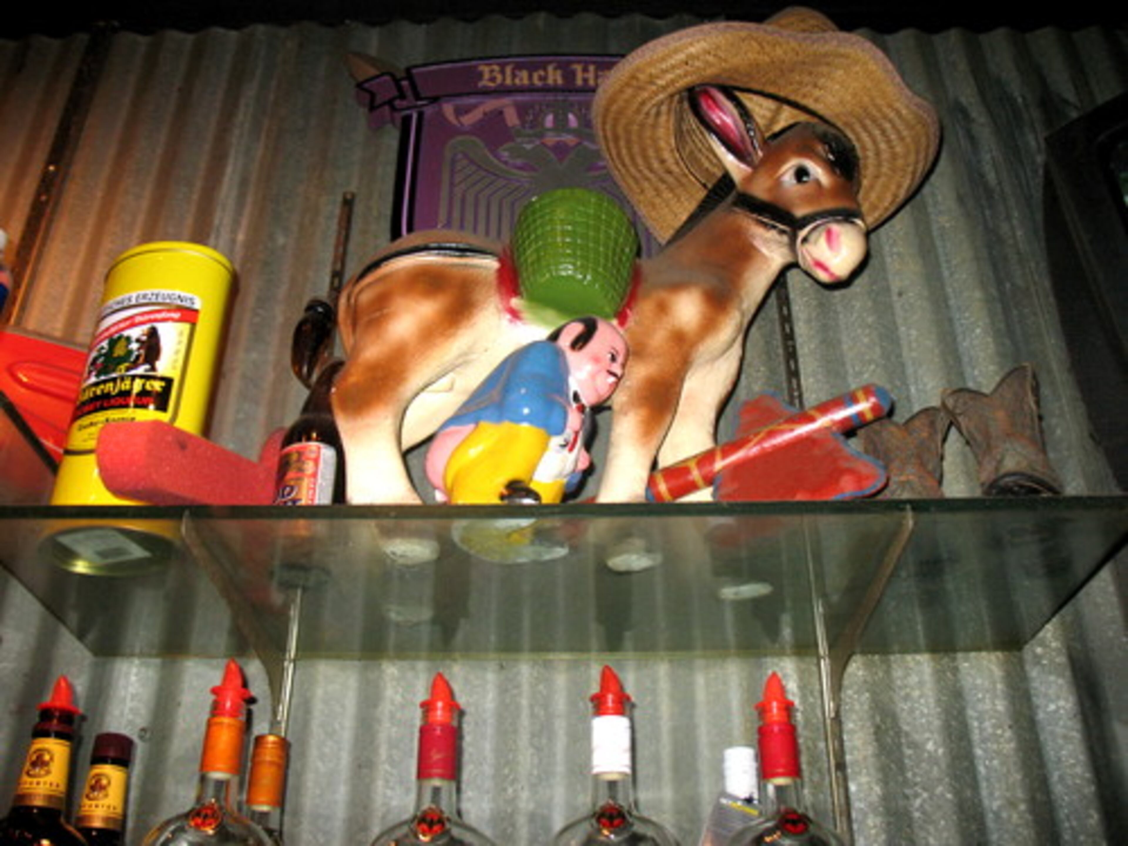 A donkey and man linger over the liquor bottles at one of the bars.