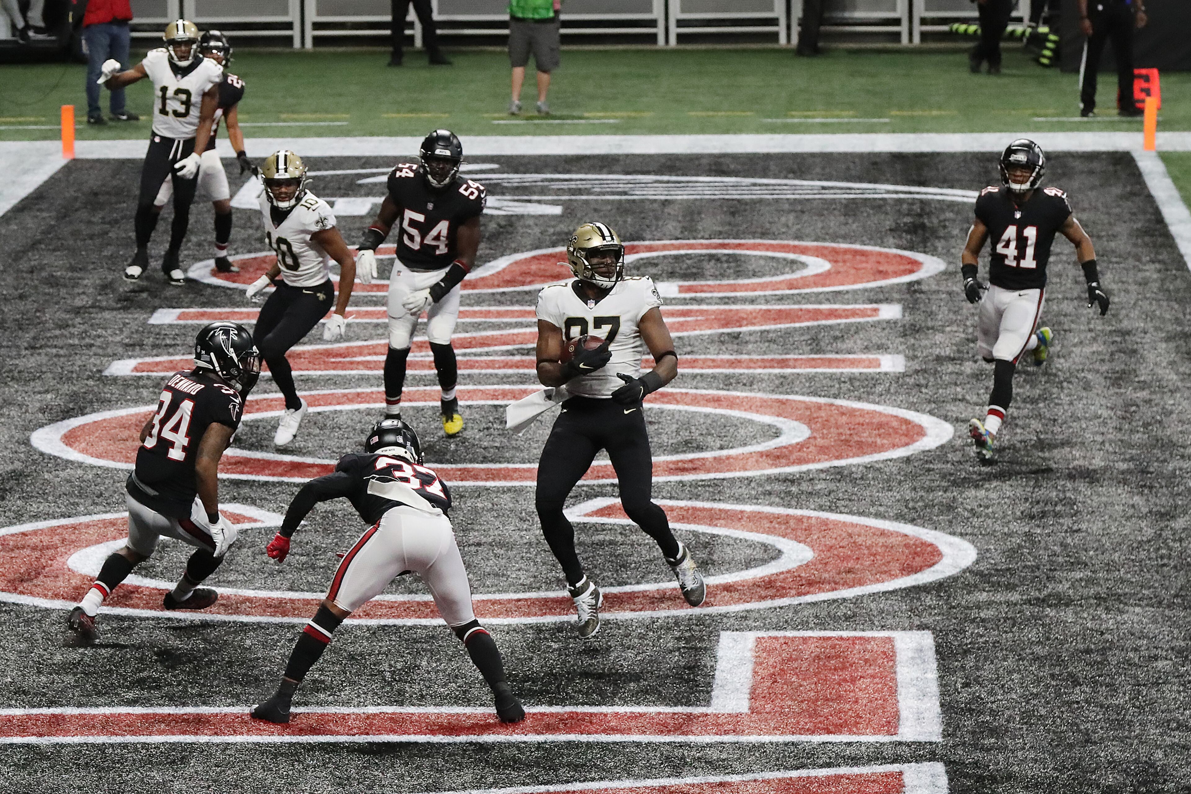 Falcons defenders surround New Orleans Saints tight end Jared Cook (center) as he catches a touchdown pass to give New Orleans a 14-6 lead during the second quarter Sunday, Dec. 6, 2020, at Mercedes-Benz Stadium in Atlanta. (Curtis Compton / Curtis.Compton@ajc.com)