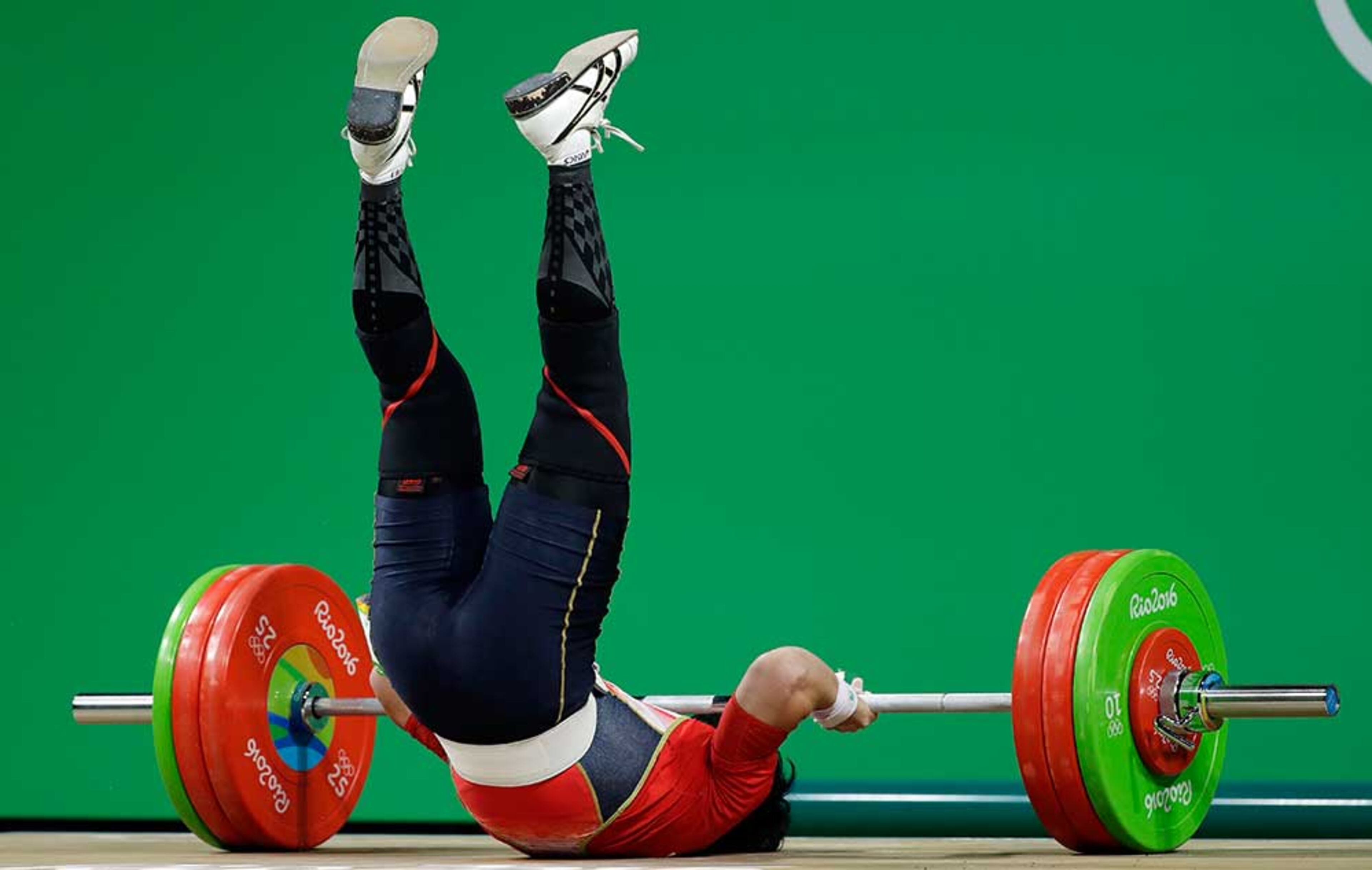 Yosuke Nakayama, of Japan, falls during the men's 62kg weightlifting competition at the 2016 Summer Olympics in Rio de Janeiro, Brazil, Monday, Aug. 8, 2016. (AP Photo/Mike Groll)