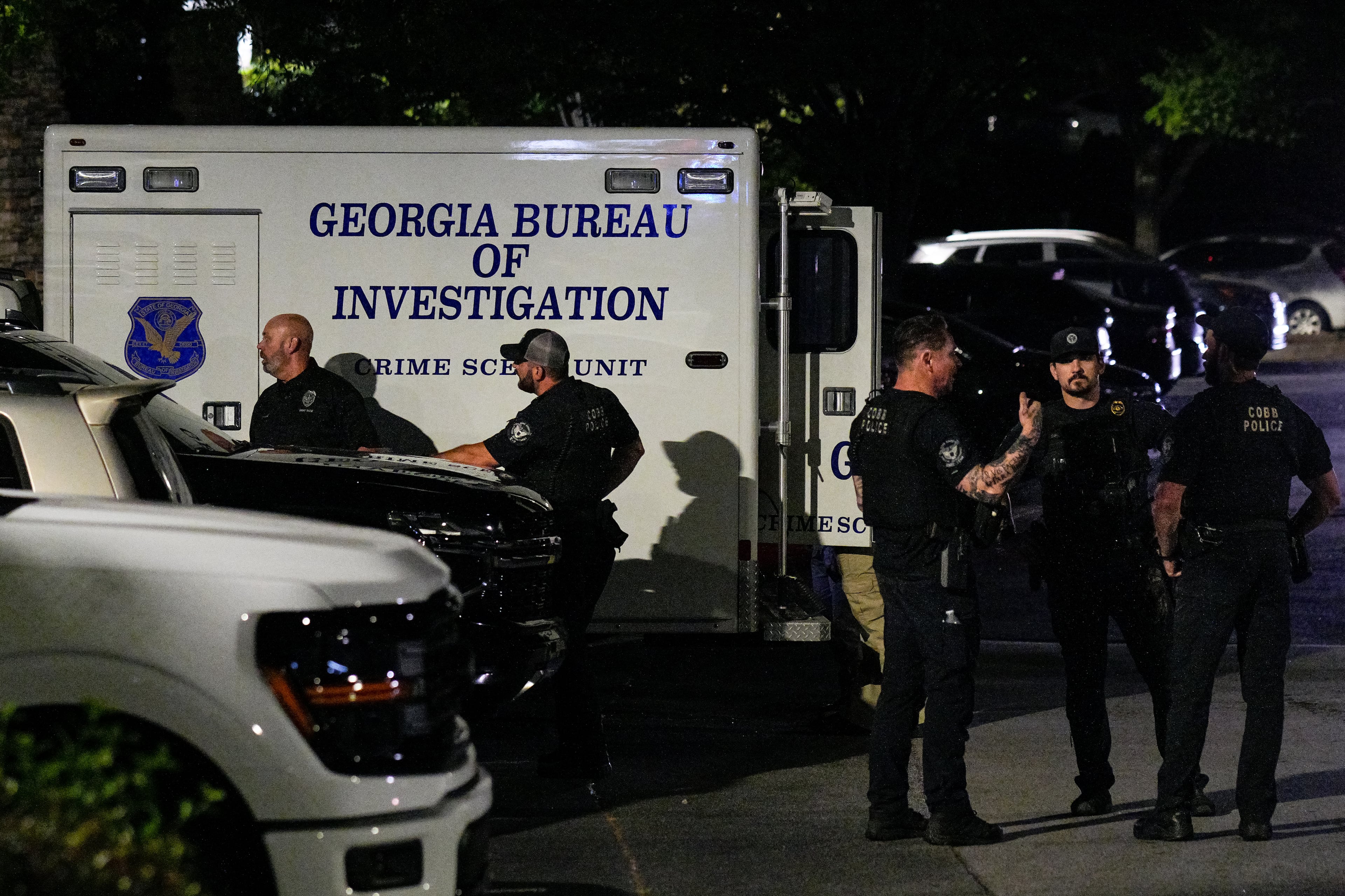 Numerous law enforcement officers, including from the GBI, were at the scene off Windy Hill Road late Tuesday. (Ben Hendren for the AJC)