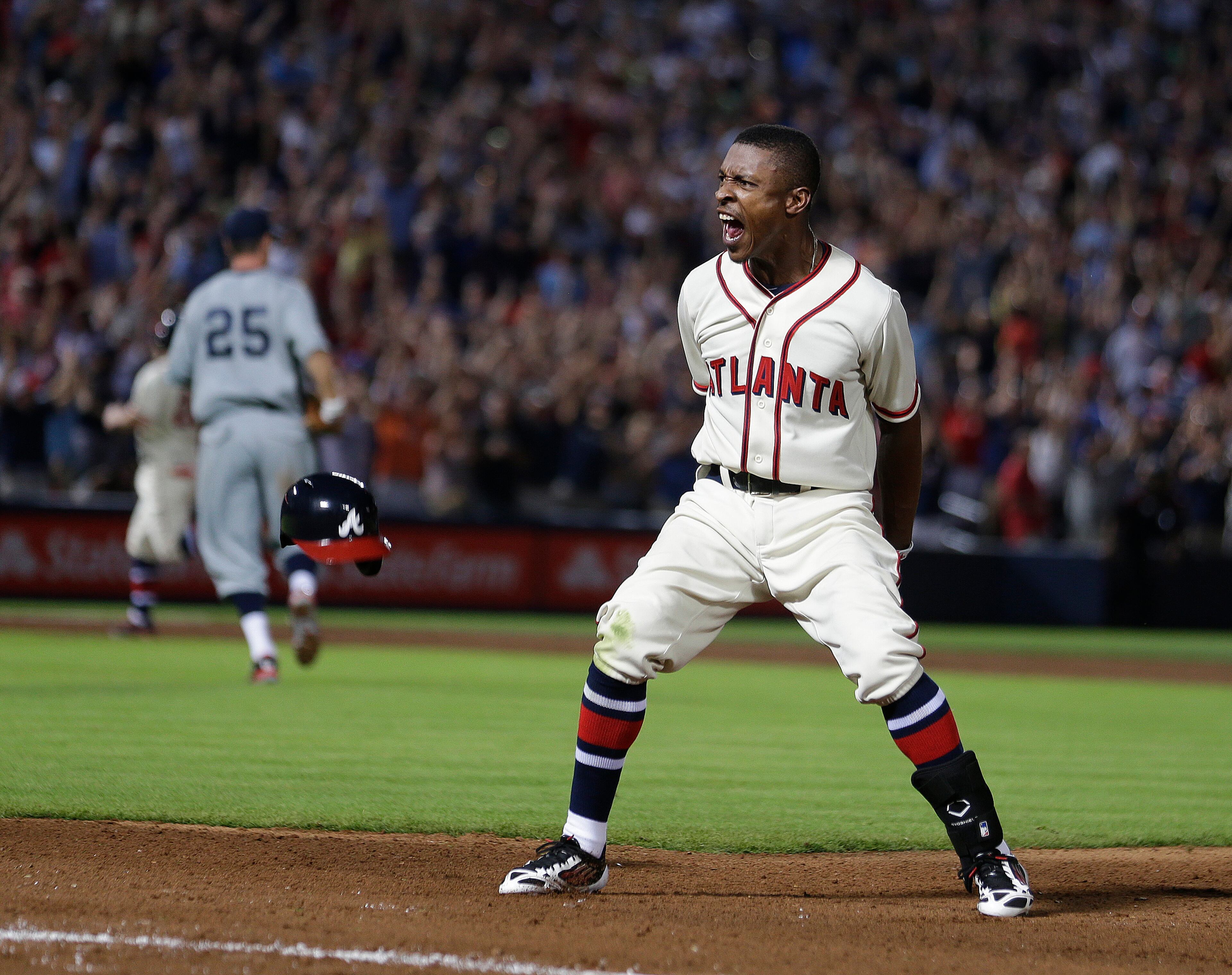 Atlanta Braves' B.J. Upton shouts after driving in the game-winning run with a base hit in the 10th inning of a baseball game against the Washington Nationals in Atlanta, Saturday, June 1, 2013. Atlanta won 3-2. (AP Photo/John Bazemore)