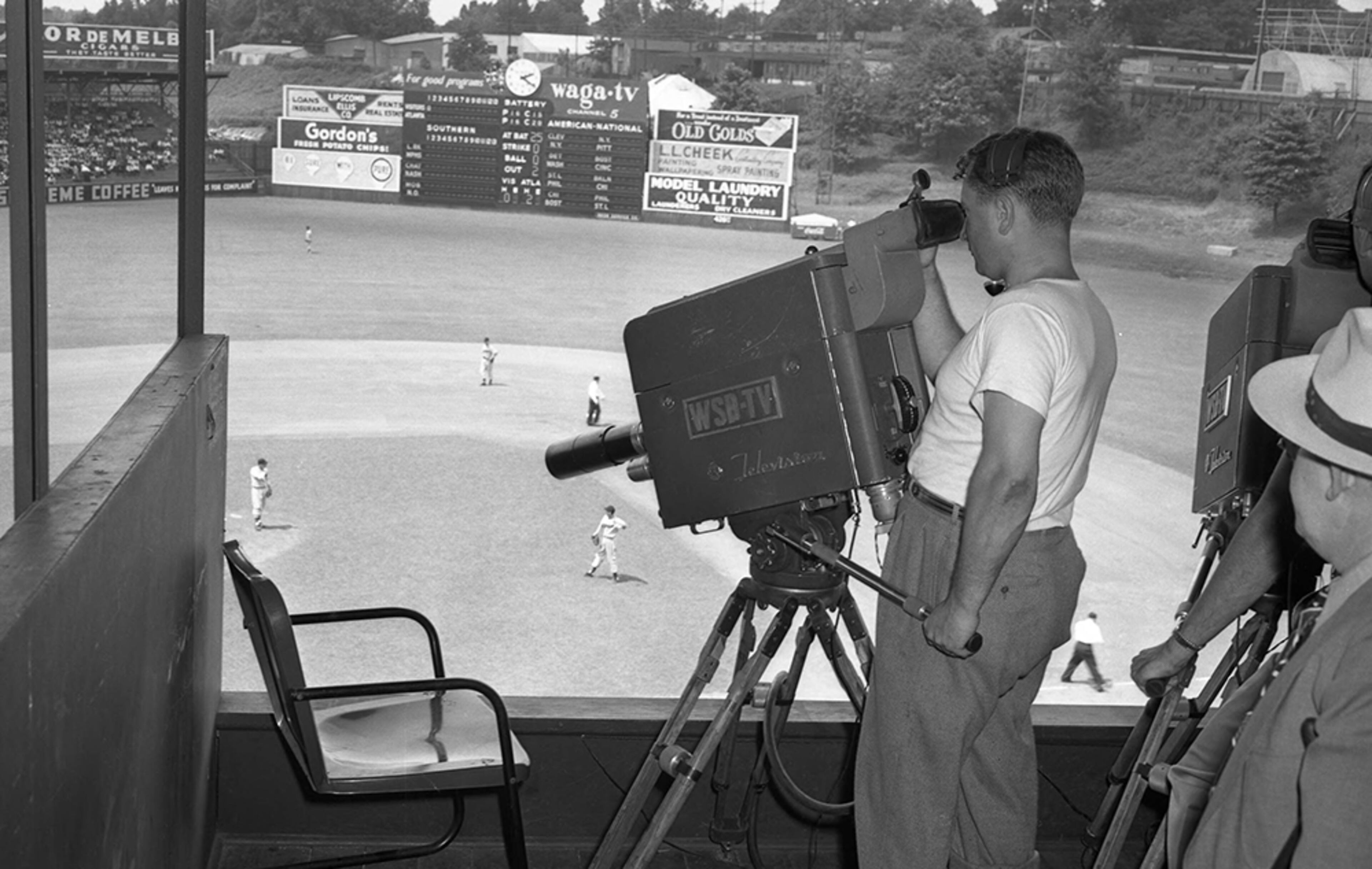 A cameraman records the action from inside the WSB-TV booth overlooking Ponce de Leon Park in 1949. WSB-TV, and later WAGA-TV, broadcast Atlanta Crackers games.