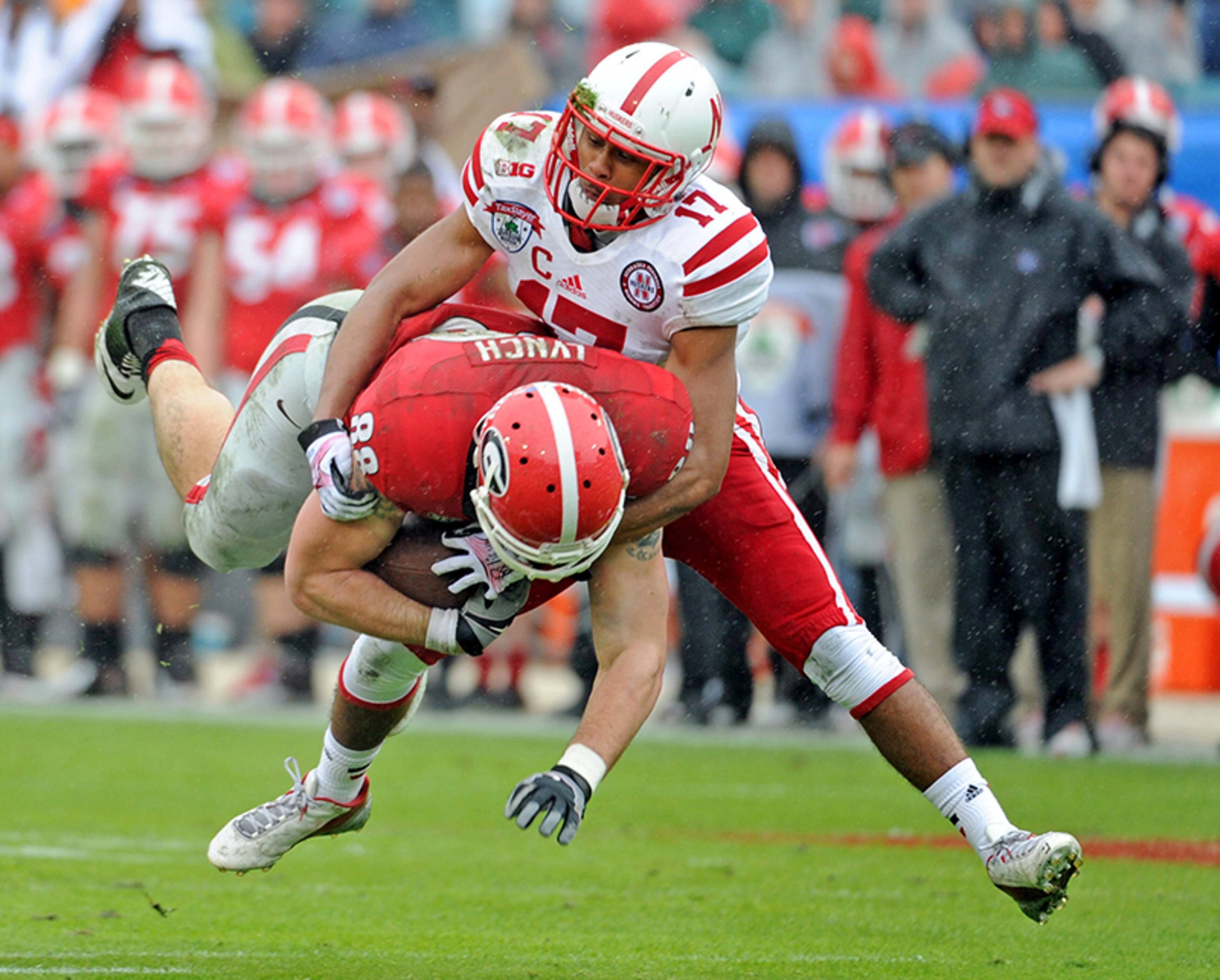 Georgia Bulldogs tight end Arthur Lynch (88) is taken down by Nebraska Cornhuskers cornerback Ciante Evans (17) during the first half of the Gator Bowl at EverBank Field in Jacksonville, Fla.