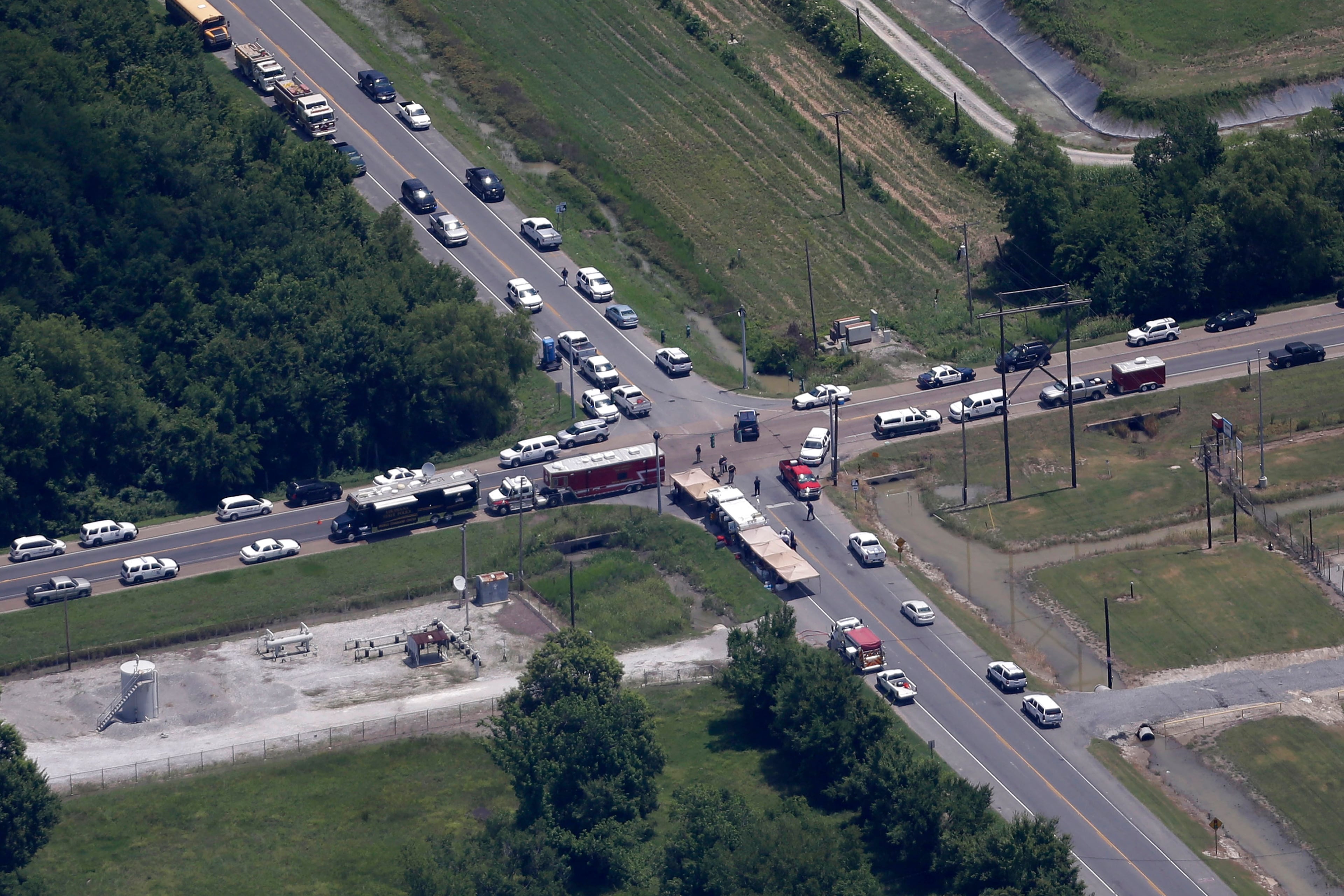 A roadblock with emergency personnel is seen in this aerial photo, near a chemical plant explosion, about 20 miles southeast of Baton Rouge in Geismer, La.