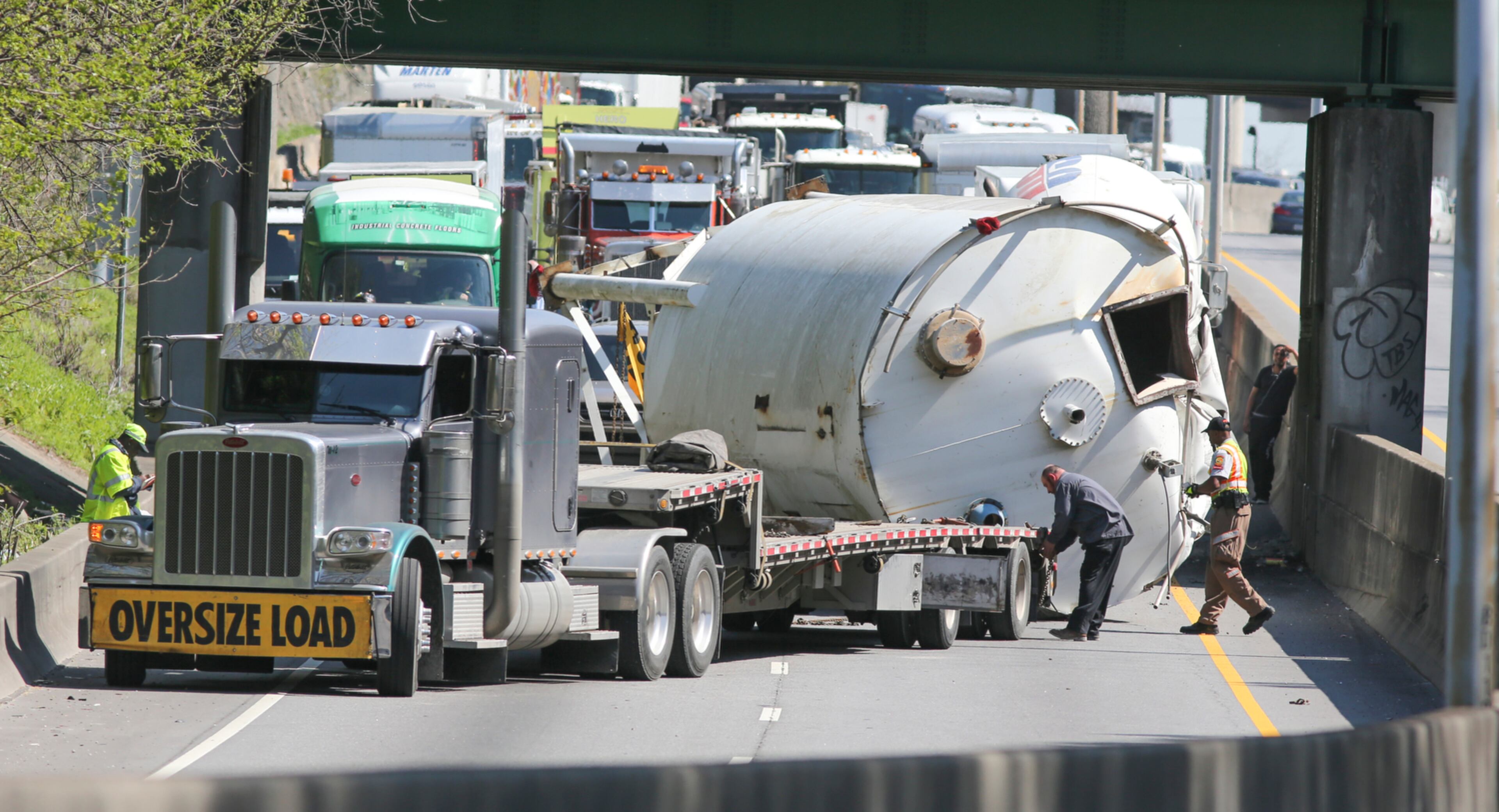 TANKER TUMBLES--March 31, 2015 Atlanta: A truck hauling a large storage tank hit an overpass on the Buford-Spring Connector late Tuesday morning, March 31, 2015 in Atlanta causing the tank to land on the southbound lanes. All southbound lanes were temporarily blocked while crews attempted to move the trailer from the roadway. Some traffic was able to pass the tank at a much slower-than-normal pace. Shortly after 1 p.m., the tank was cleared from the roadway. No injuries were reported in the incident, which was under investigation by the Georgia State Patrol. JOHN SPINK / JSPINK@AJC.COM