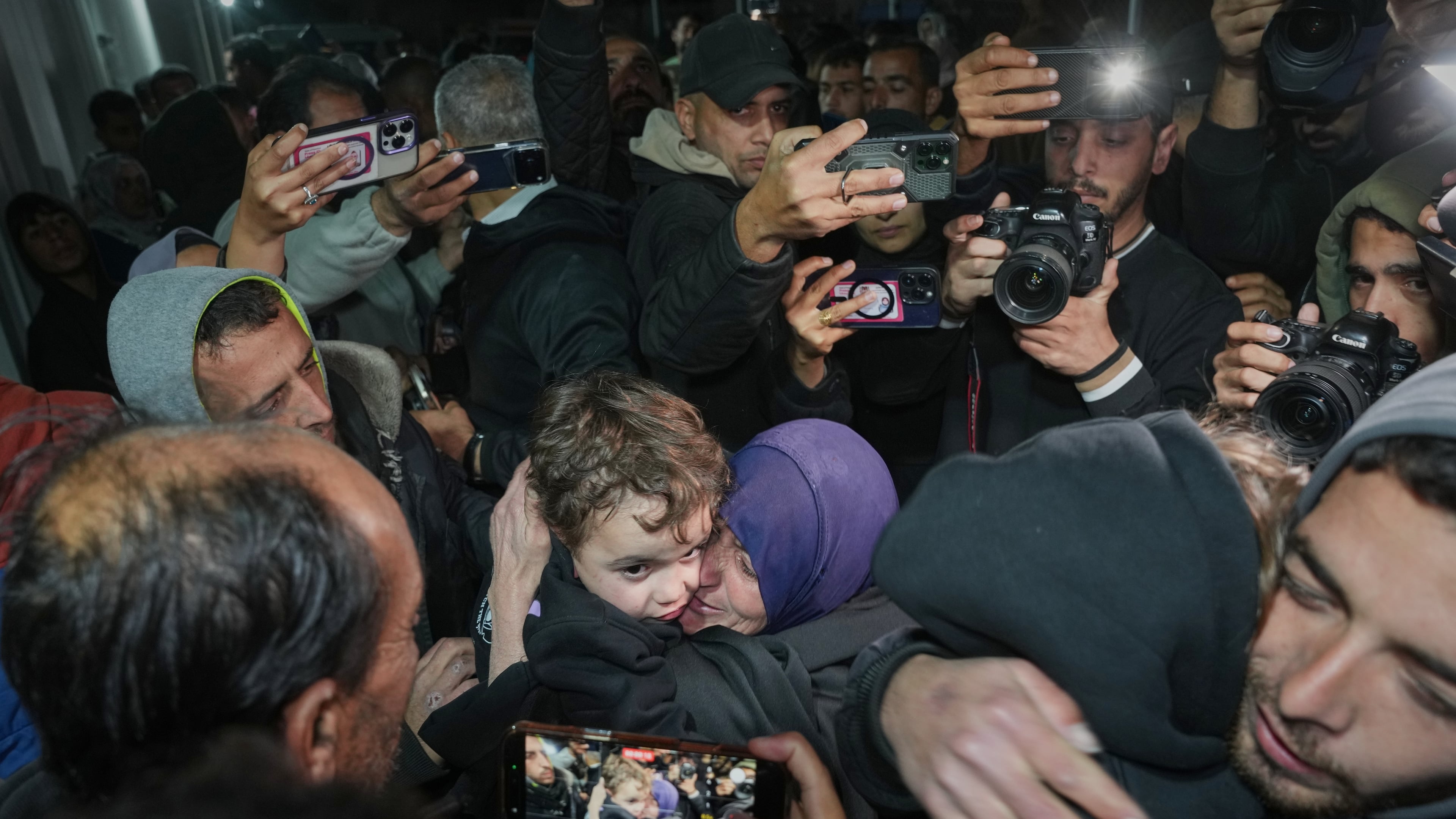 Najat Rubaie, center right, embraces one of her grandsons after they arrive with their mother as part of a group of about a dozen Palestinian returnees allowed into Gaza following the long-awaited reopening of the Rafah border crossing, at Nasser Hospital in Khan Younis, southern Gaza Strip, early Tuesday, Feb. 3, 2026. (AP Photo/Abdel Kareem Hana)