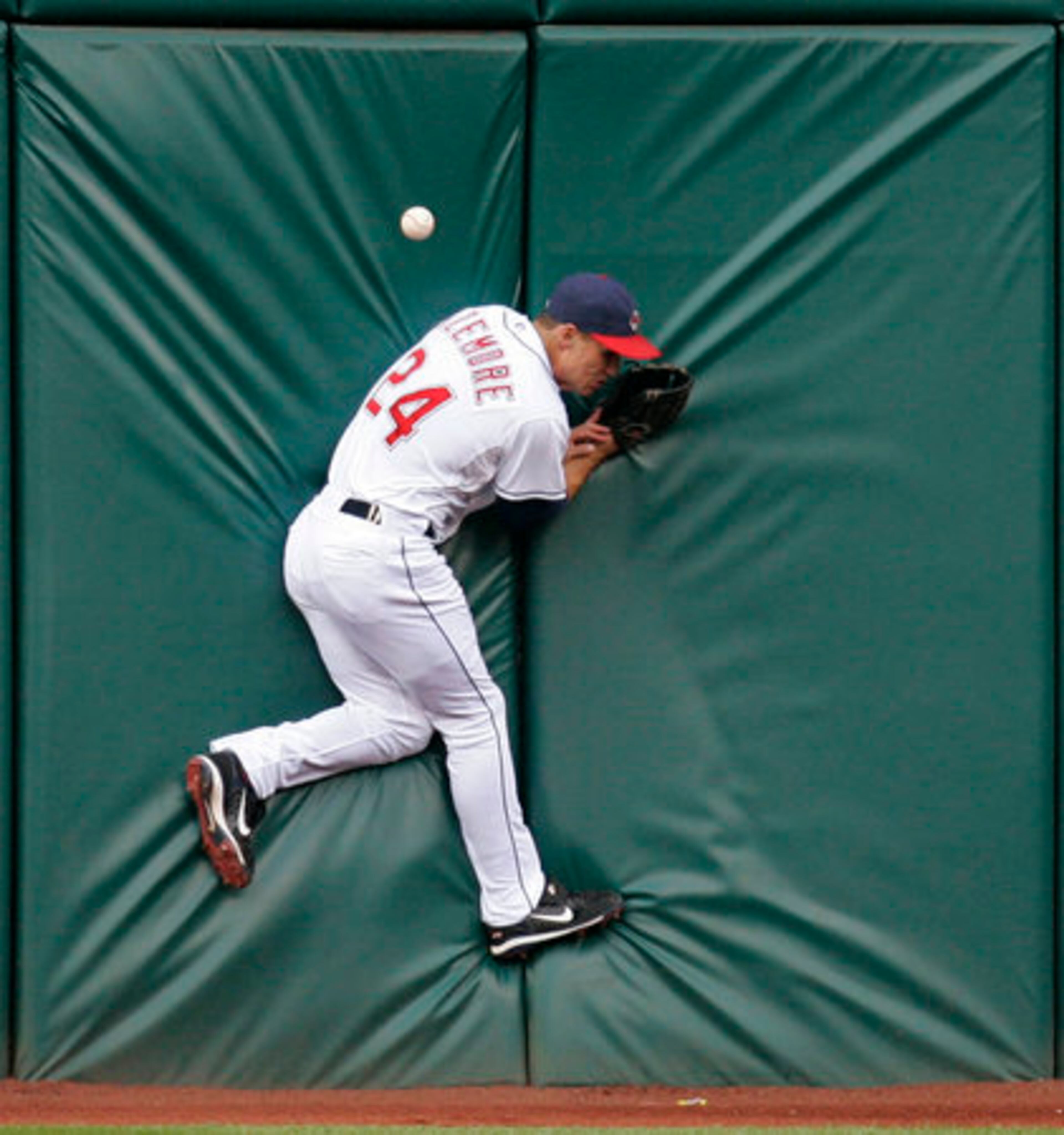 Cleveland's Grady Sizemore jumps into the wall trying to catch a double hit by San Francisco's Rich Aurilia in Cleveland on Wednesday.