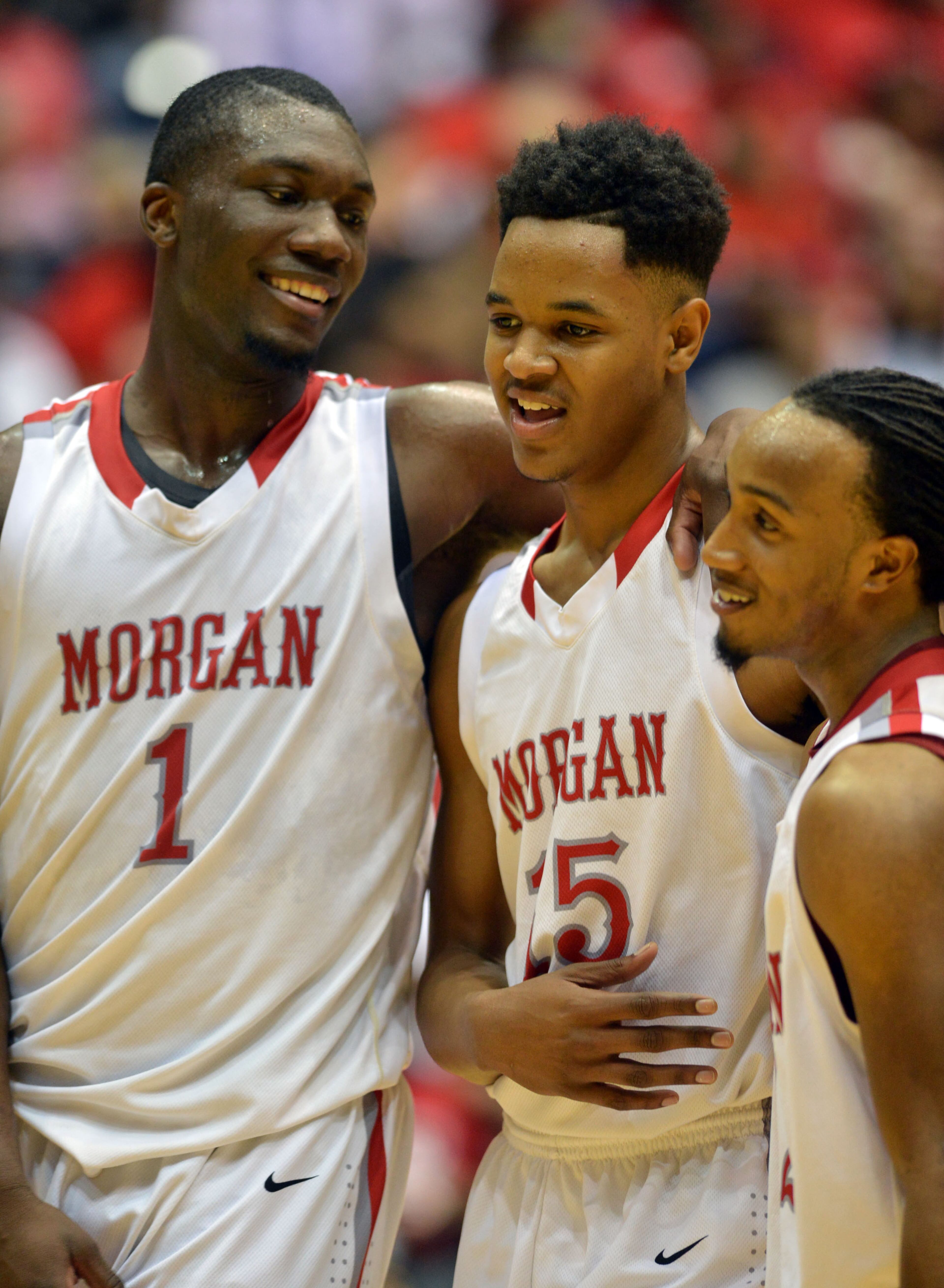 Morgan County Bulldogs C.J. Thurman #1, Jailyn Ingram #15 and Davon Gibbs #12 start to celebrate late in the 4th quarter. Coverage of the Class AAA boys basketball championship between the Buford Wolves and Morgan County Bulldogs at the Macon Coliseum Saturday, March 8, 2014. Morgan County won handily, beating the Buford Wolves 69-45.