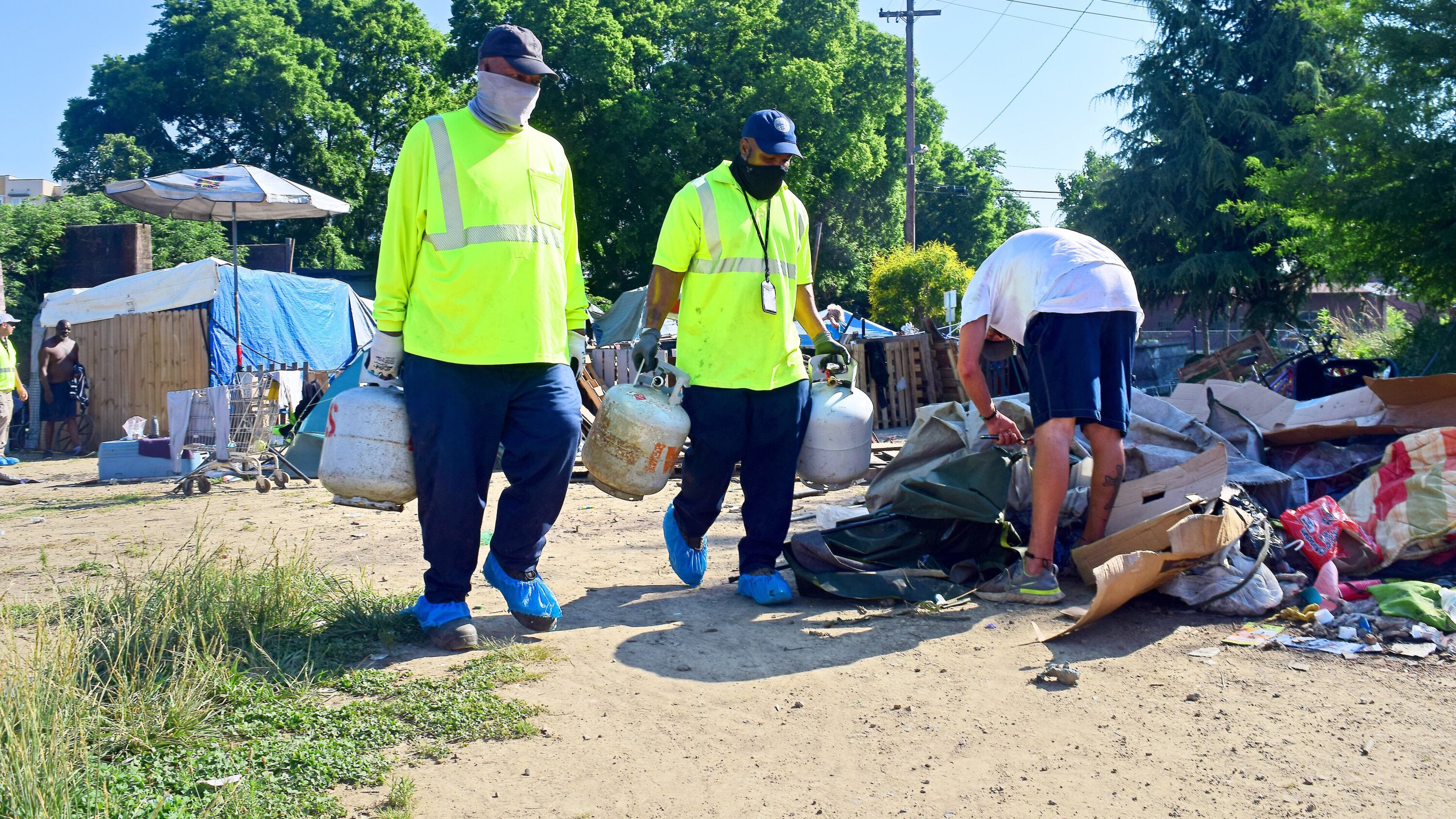 Staff Photo by Robin Rudd / City of Chattanooga Public Works employees remove recyclables and hazardous materials from the East 11th Street homeless camp on June 1, 2022. The City of Chattanooga is preparing to close the East 11th Street homeless camp and clear the property.