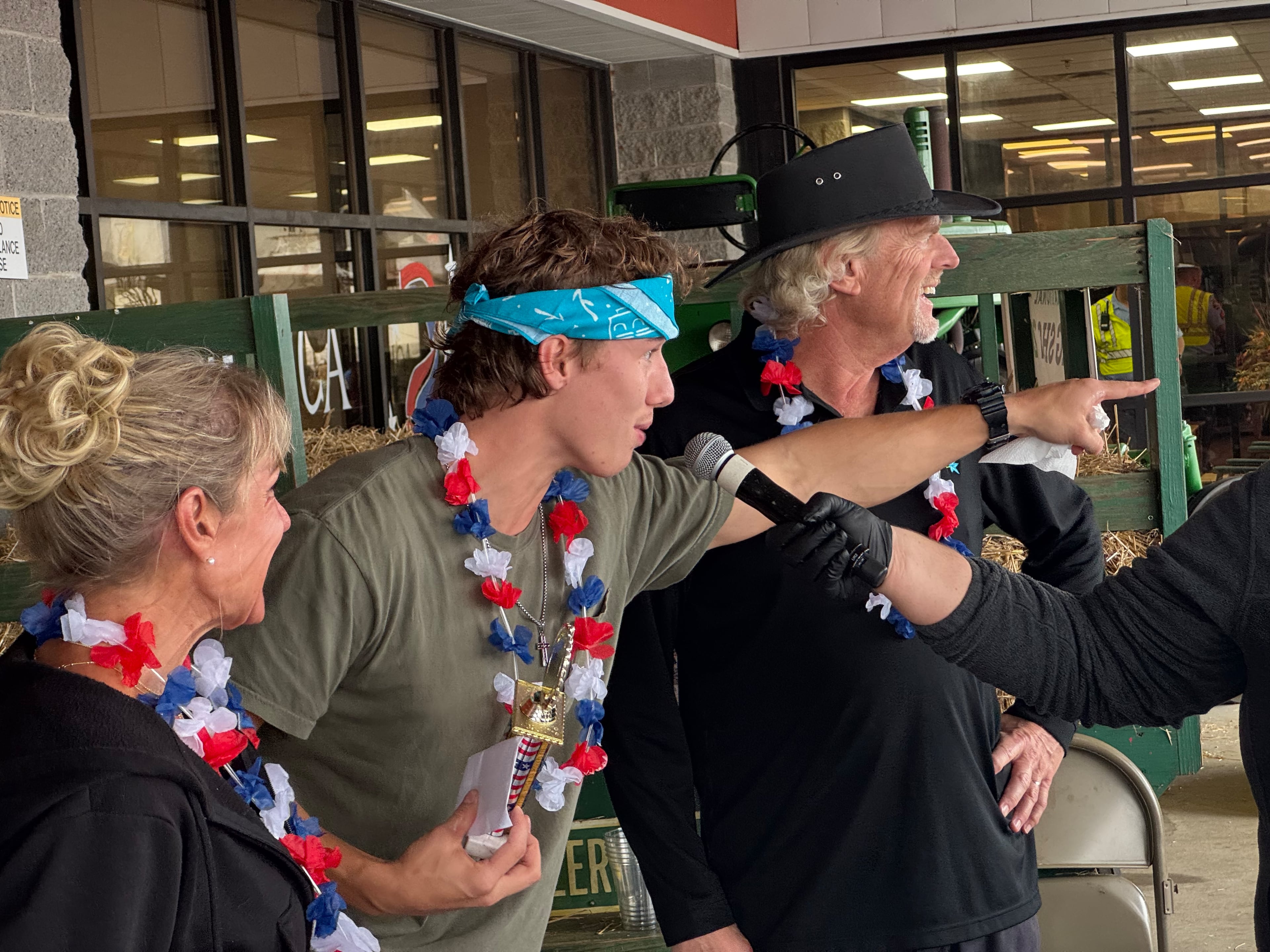 James Dean of Brunswick holds his trophy after winning the corn dog-eating contest. (Caleb Groves/AJC)