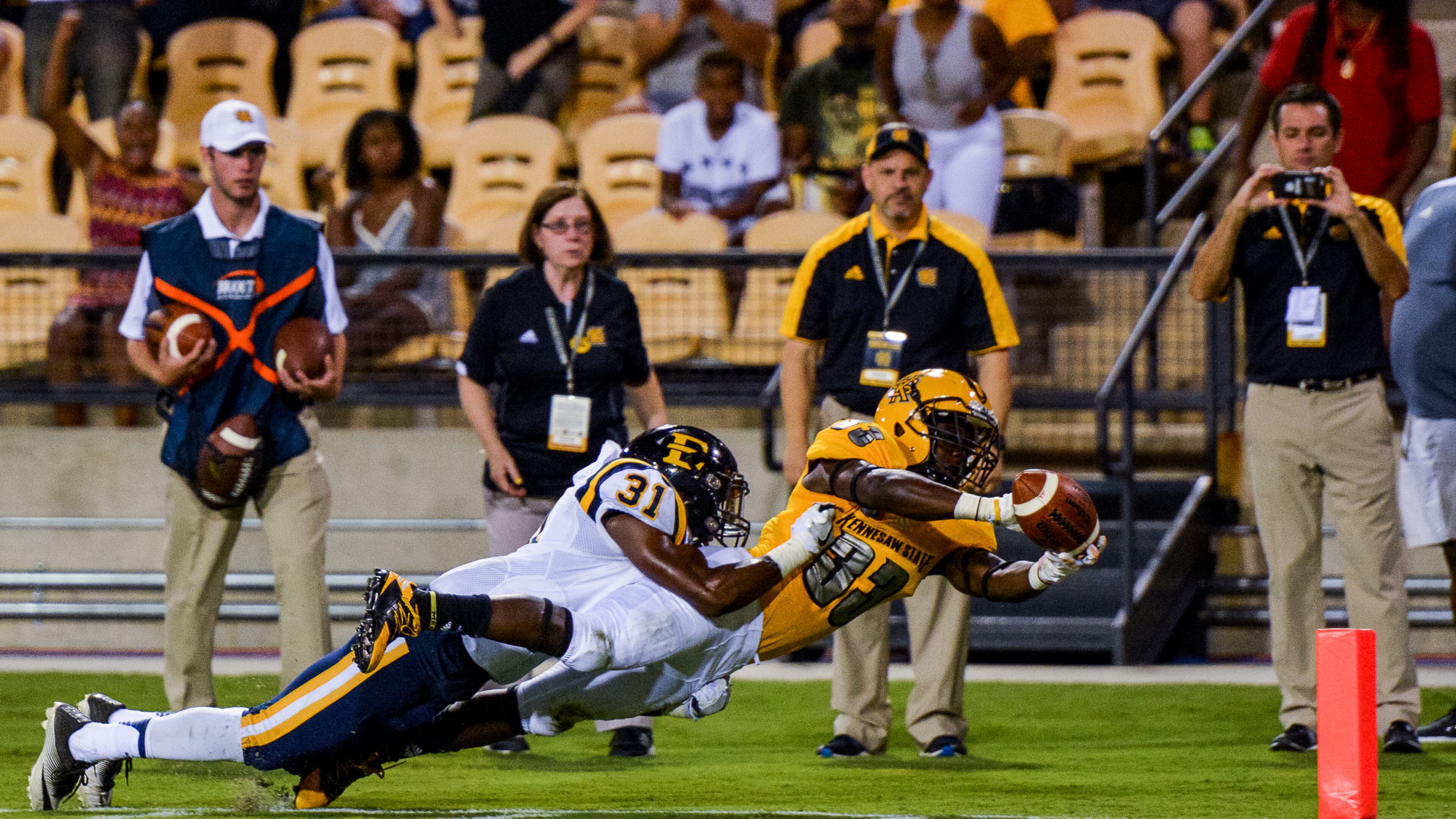 Sophomore running back Darnell Holland (33) dives for the pylon as junior cornerback Paul Hunter (31) makes a touchdown-saving tackle, Saturday, Sept. 3, 2016 (AJC/Cory Hancock)