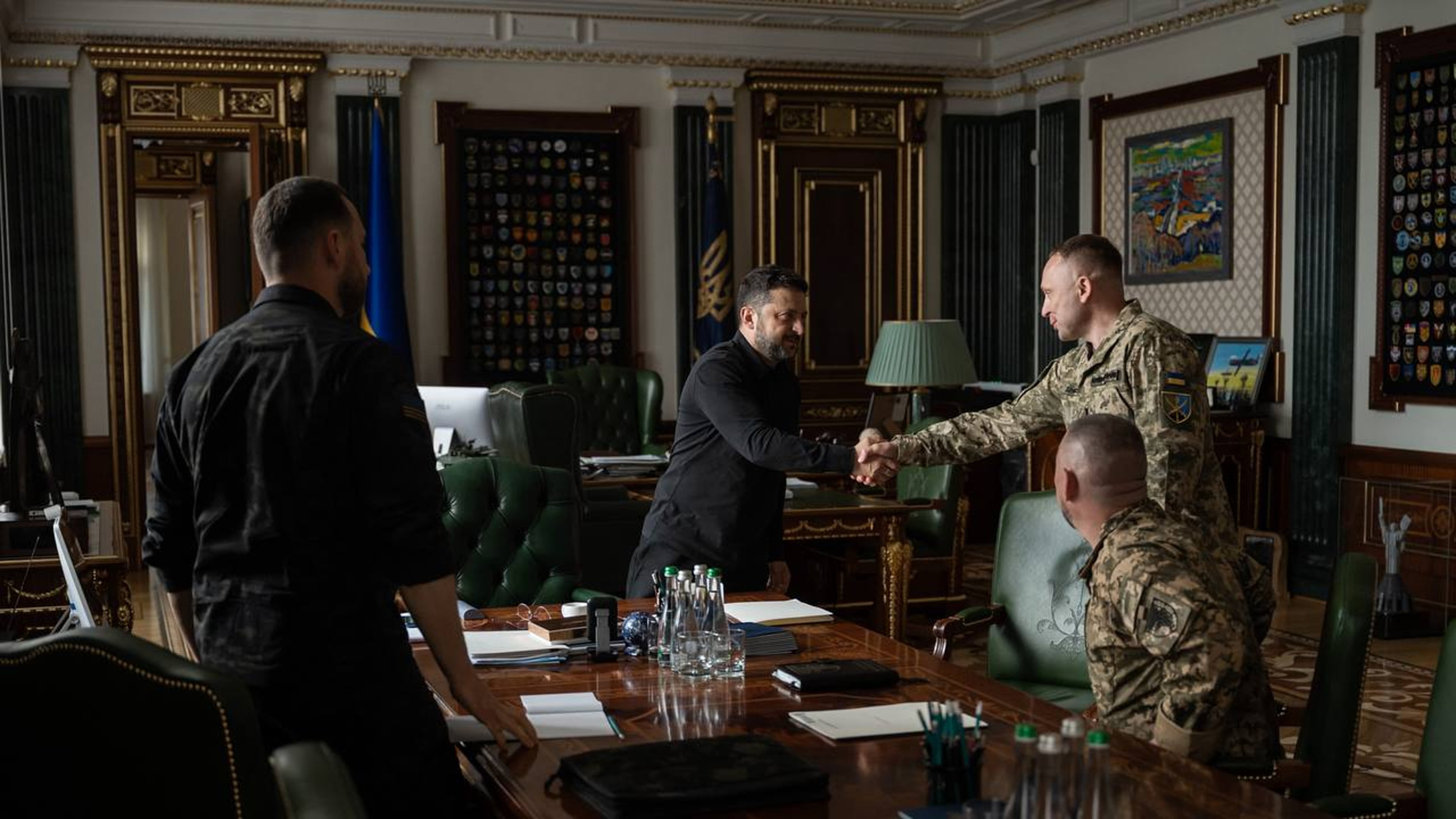 In this photo provided by the Ukrainian Presidential Press Office, Ukrainian President Volodymyr Zelenskyy, center, shakes hands with new commander-in-chief of Ukraine's Armed Forces Mykhailo Drapatyi during their meeting in Kyiv, Ukraine, Monday, July 20, 2026. (Ukrainian Presidential Press Office via AP)