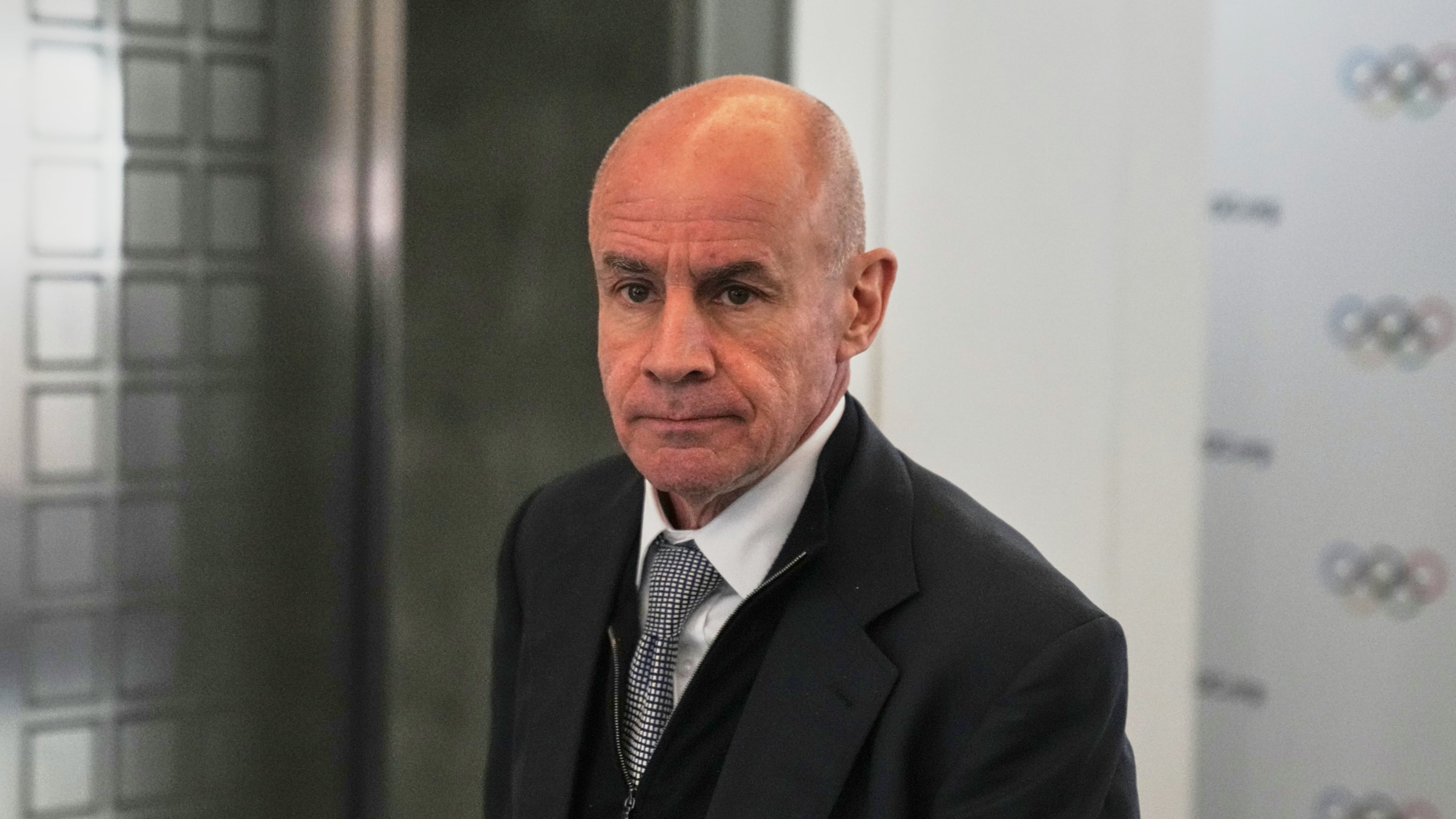 FILE - Candidate to the presidency of the International Olympic Committee Johan Eliasch arrives at the mixed zone during a break of the 144th session, which will elect the new IOC President, in Costa Navarino, western Greece, March 19, 2025. (AP Photo/Thanassis Stavrakis, File)