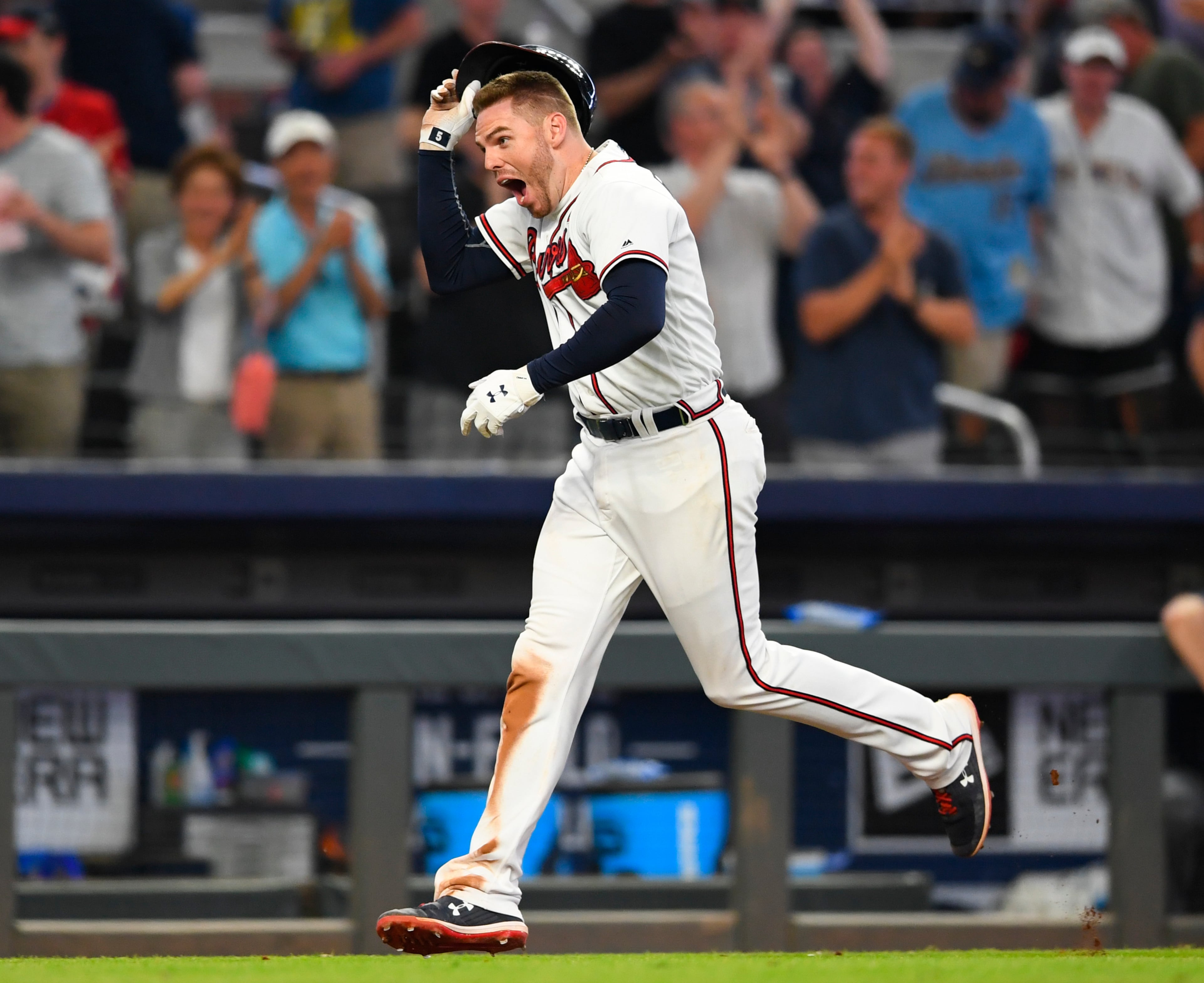 Freddie Freeman celebrates his walk-off home run as he runs the bases. (AP Photo/John Amis)